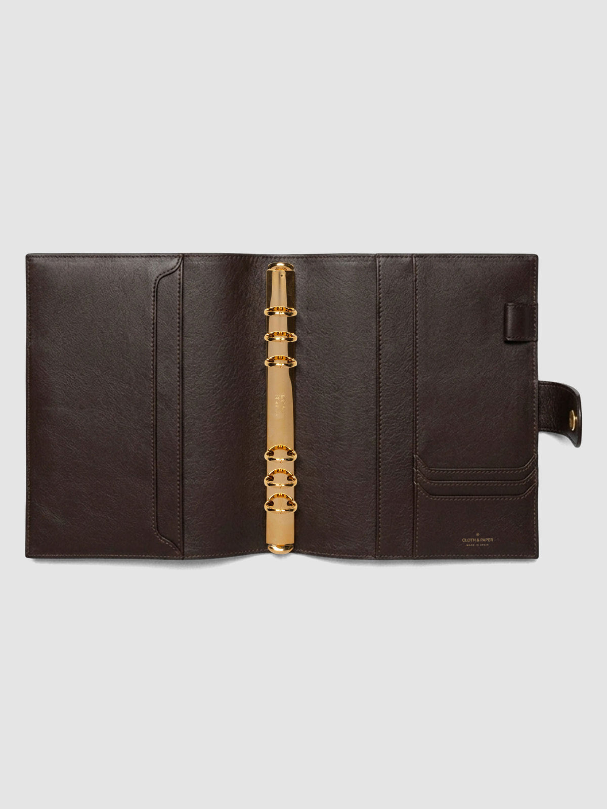 Open dark brown genuine leather A5 6-ring planner cover showing full interior, gold Krause rings and pockets visible on both sides