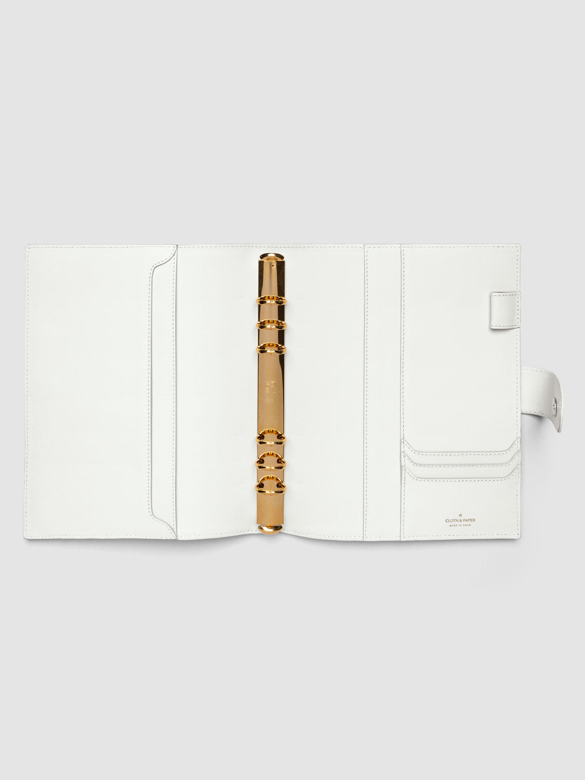 Open off-white genuine leather A5 6-ring planner cover showing full interior, gold Krause rings and pockets visible on both sides