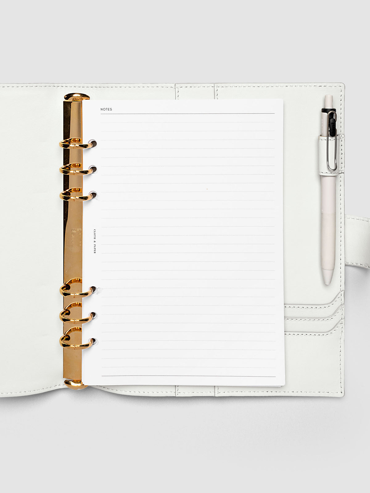 Open off-white genuine leather A5 6-ring planner cover with inserts inside, gold Krause rings visible