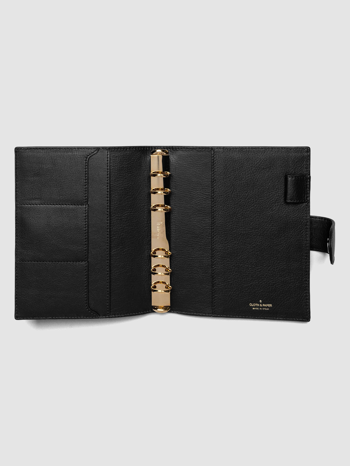 Open black genuine leather Personal Wide 6-ring planner cover showing full interior, gold Krause rings and pockets visible on both sides