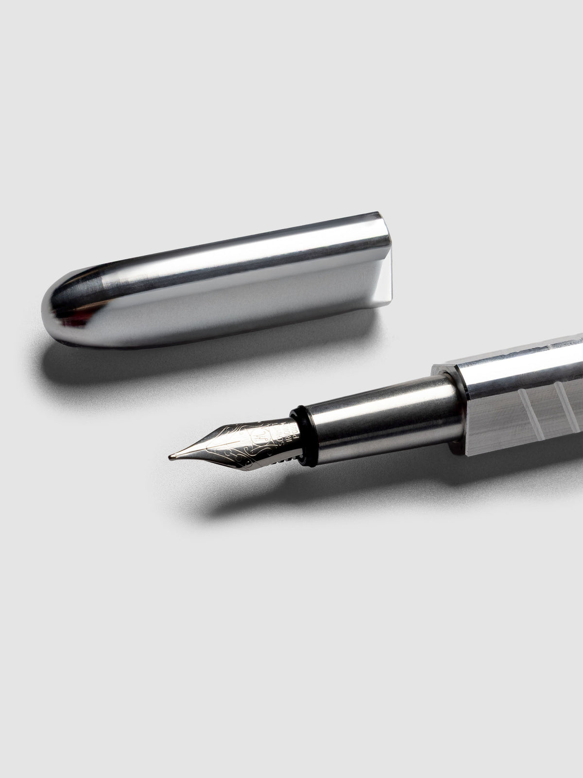 Kolo Tino Fountain Pen in the color Raw Aluminum, a silver toned metal barrel and a silver medium nib shown with cap off.