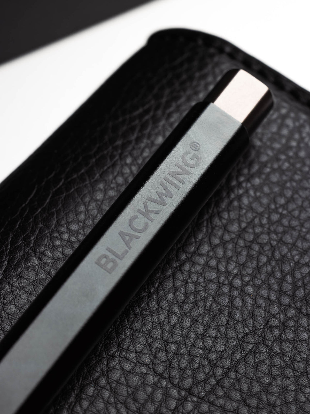 Detail shot of the Blackwing Pen in the color black featuring the brand's logo.