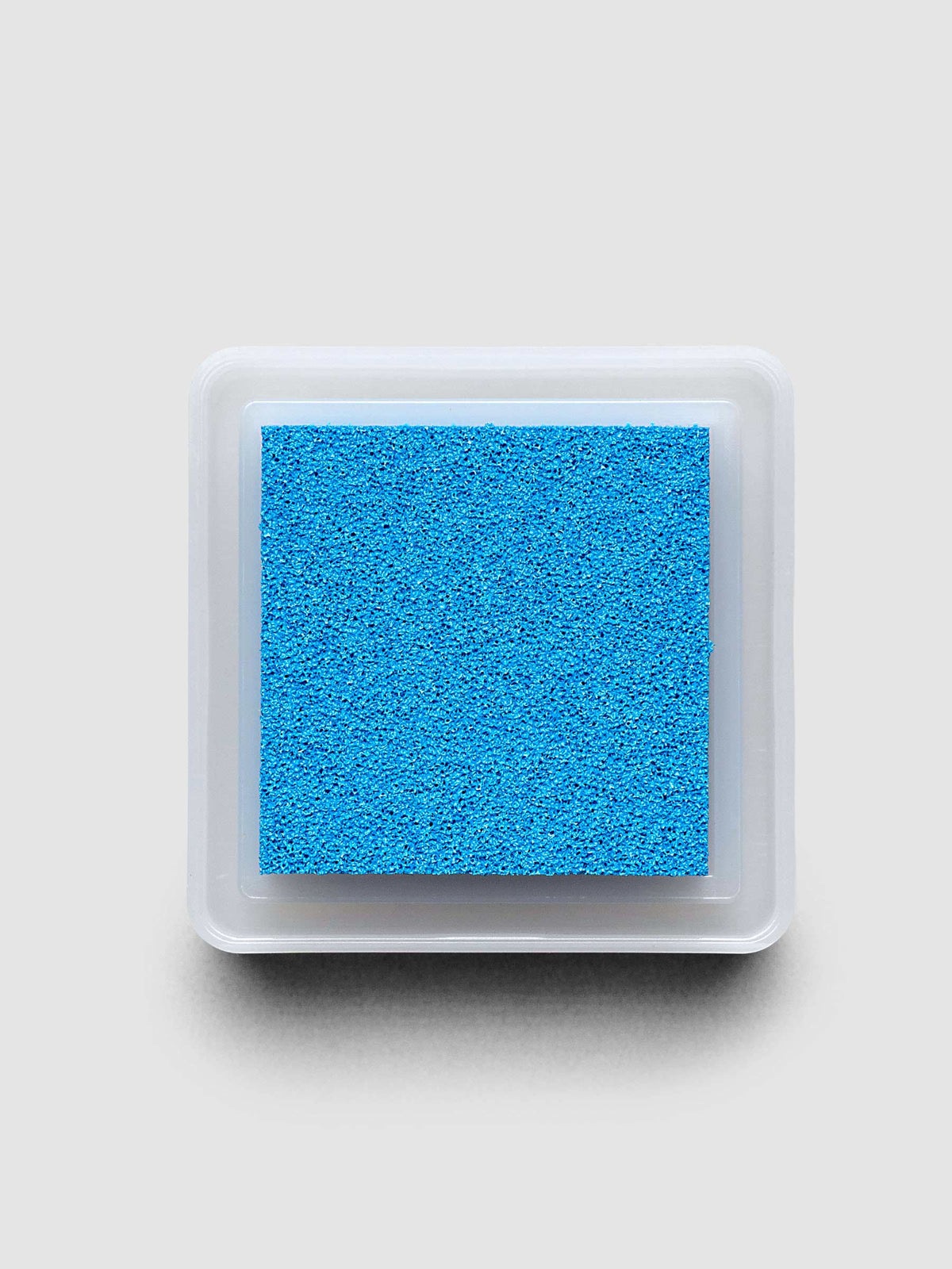 Artnic Stamp Ink Pad in cyan seen from the side with cover on