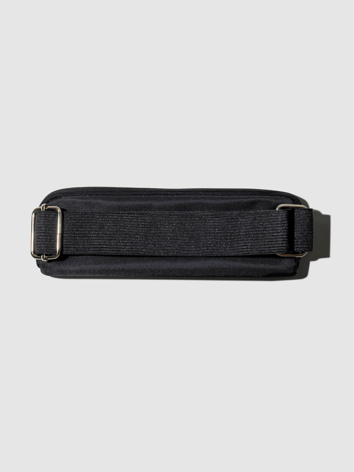 Notebook pouch shown with its back facing forward to show the adjustable strap. Color shown is Avant Garde.