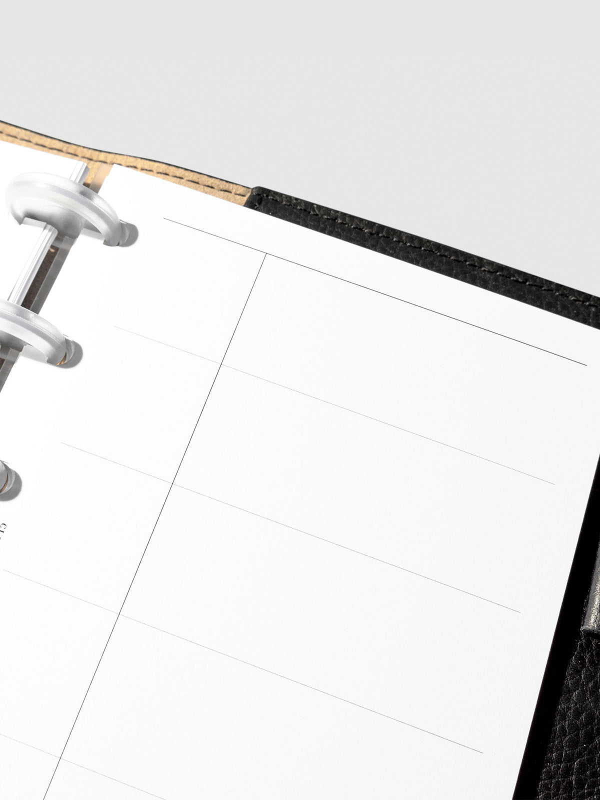 Set of inserts displayed inside a black leather planner.