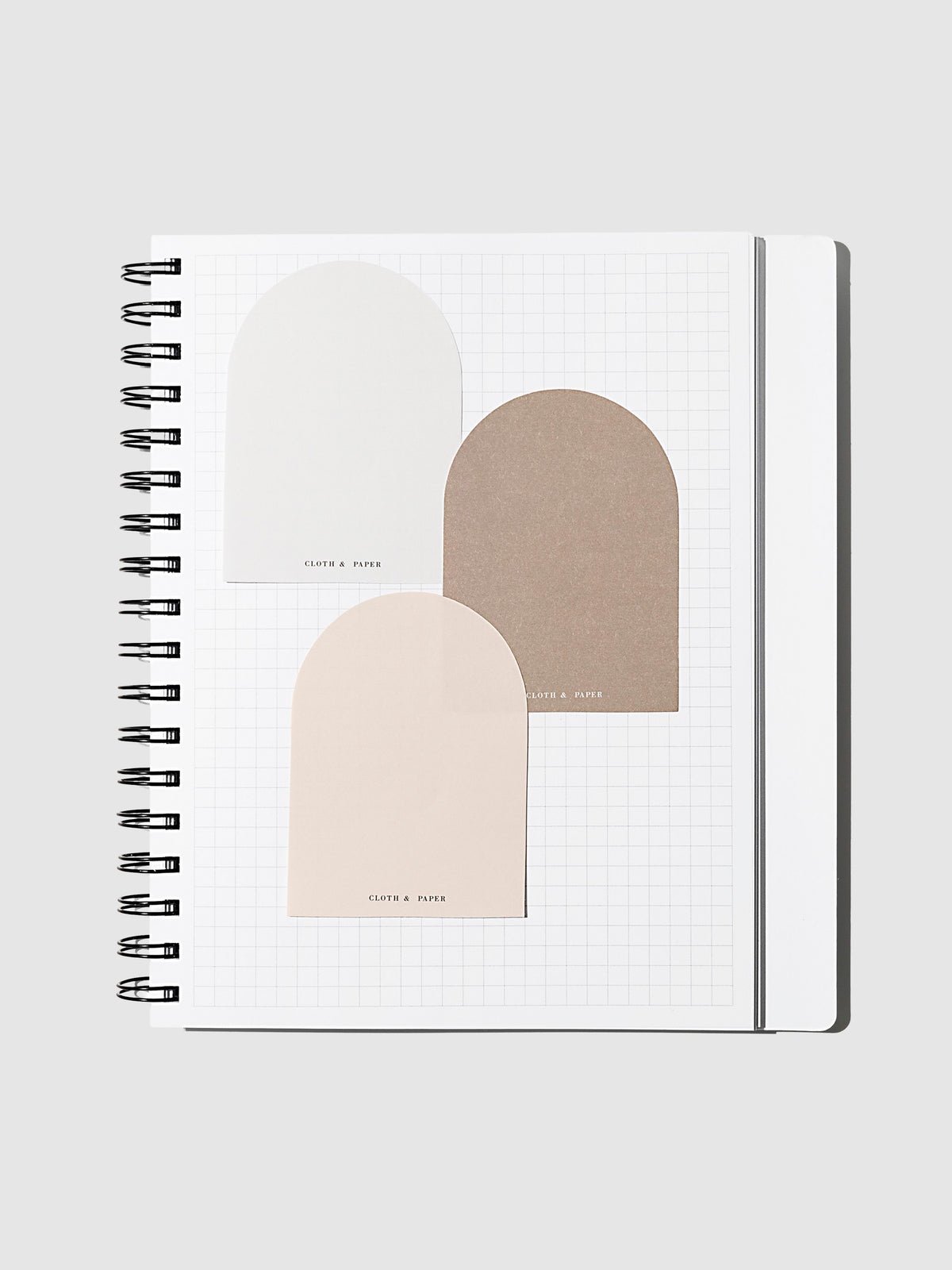 Angora, Beignet, and Cortado sticky notes layered over each other inside of a graph notebook on a neutral background.