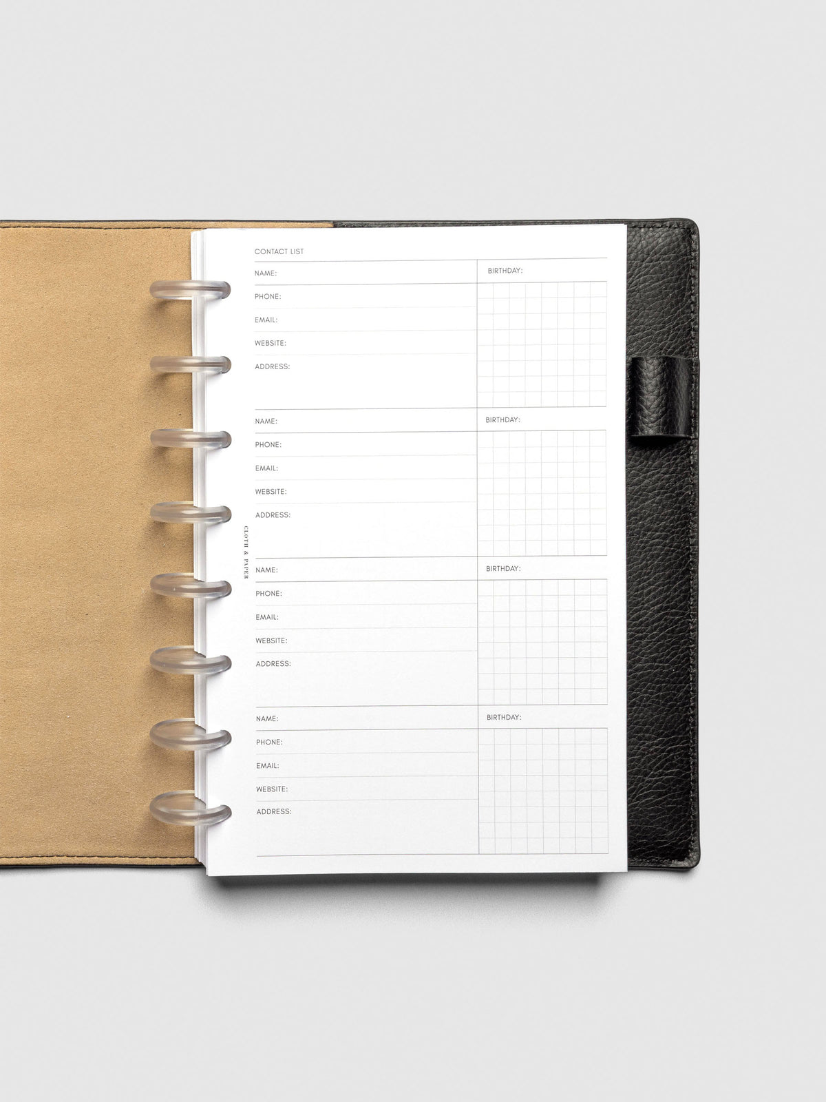 Refreshed Contact List Planner Inserts styled inside a black leather agenda. 