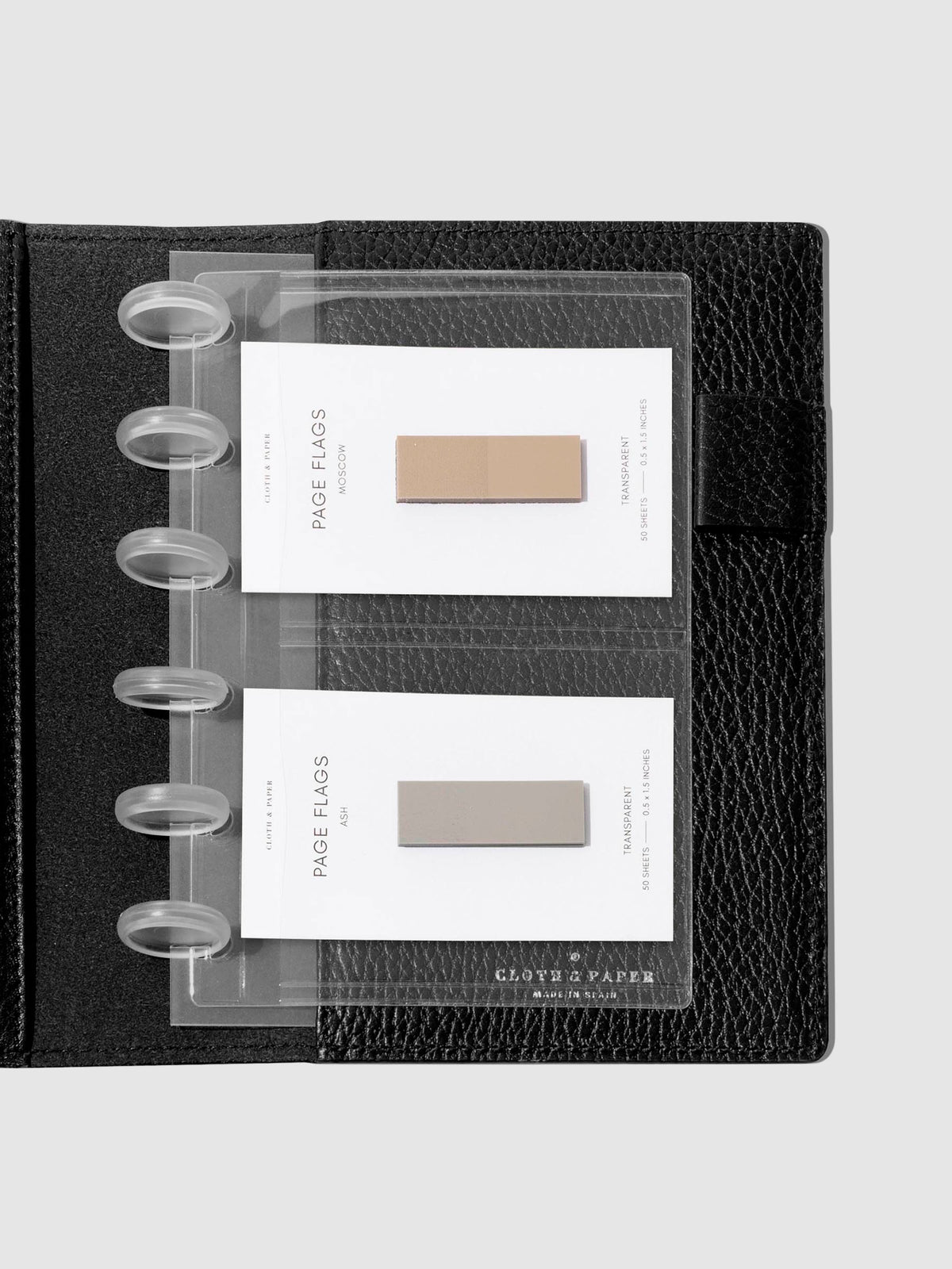 Credit card holders in use inside a black leather folio. Page flags are stored in the open pockets. Size shown is CP Petite. 