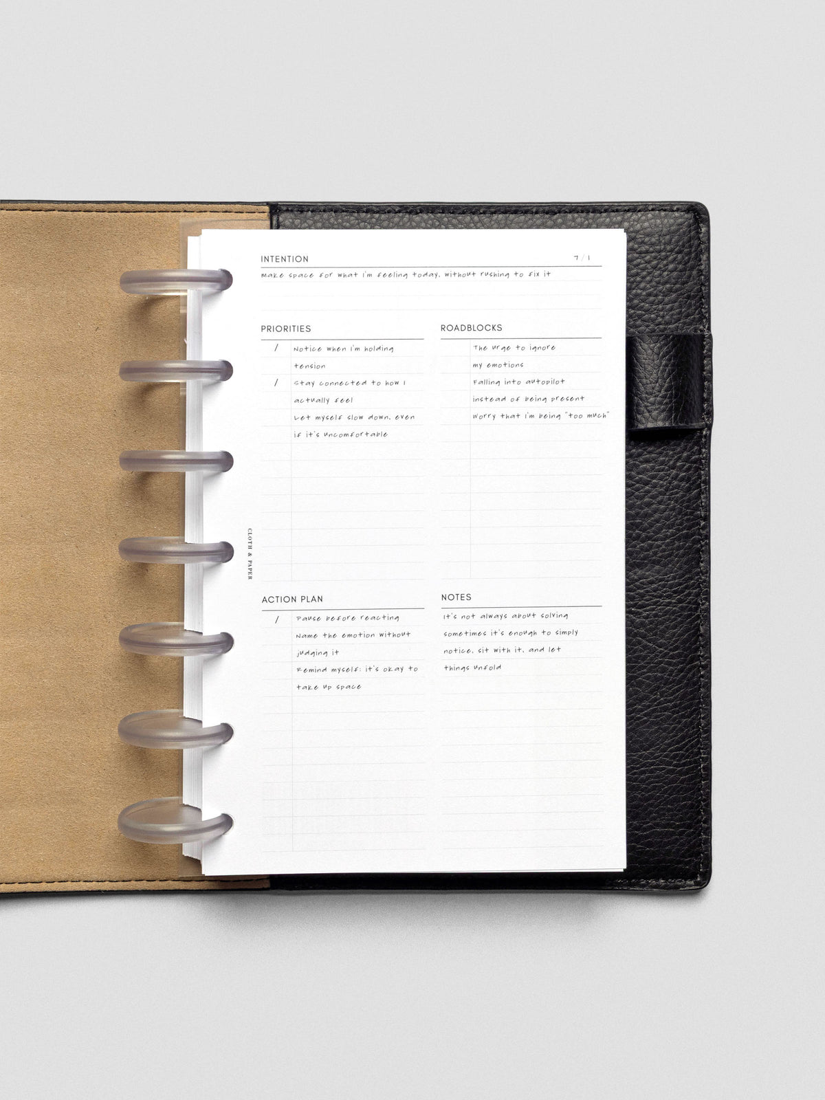Daily Intention Planner Inserts show filled out in Half Letter size disc bound in a leather cover.
