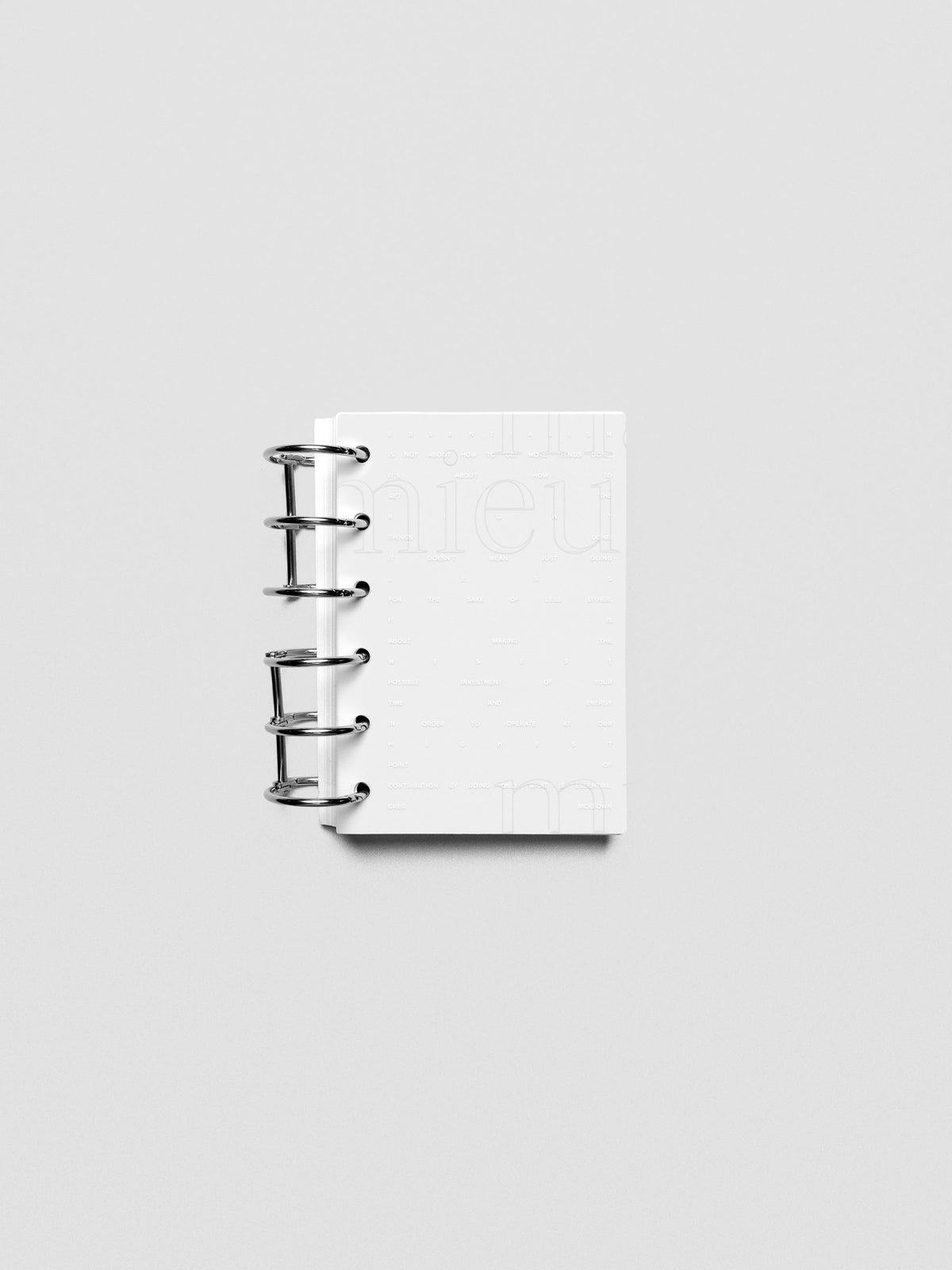 Essentialism Dashboard Duo reading "moins mai mieux" in size Pocket shown ringbound.