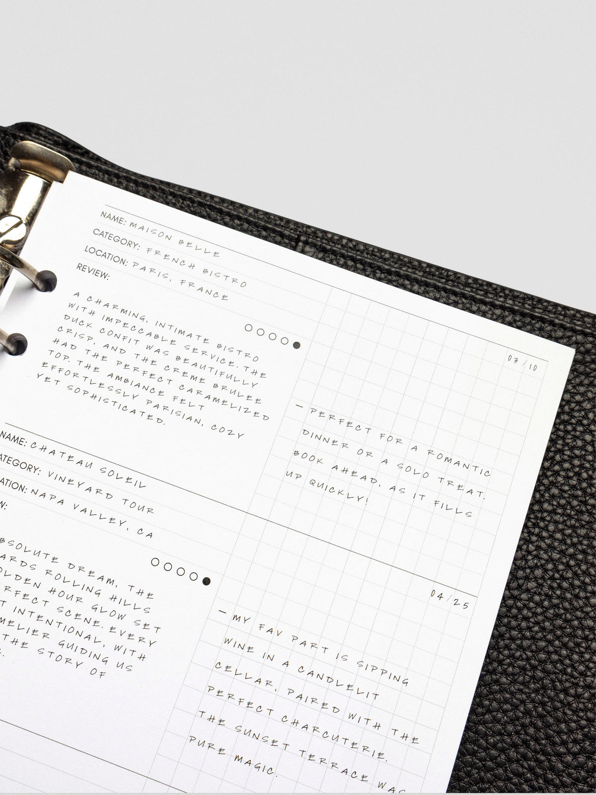 Filled-in demo page of the Experience Tracker Inserts, with handwritten reviews for a French bistro and a vineyard tour, using both the structured and grid sections.