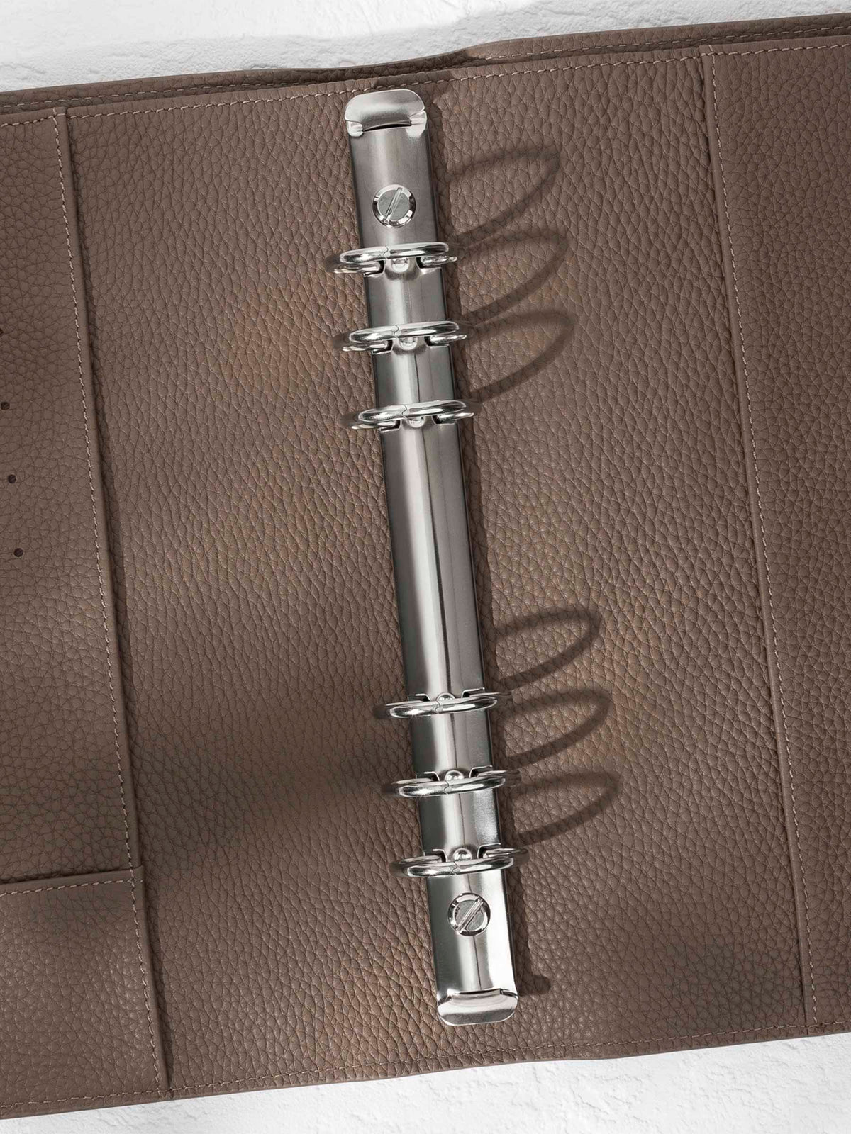 Closeup of silver hardware in a cortado leather agenda.