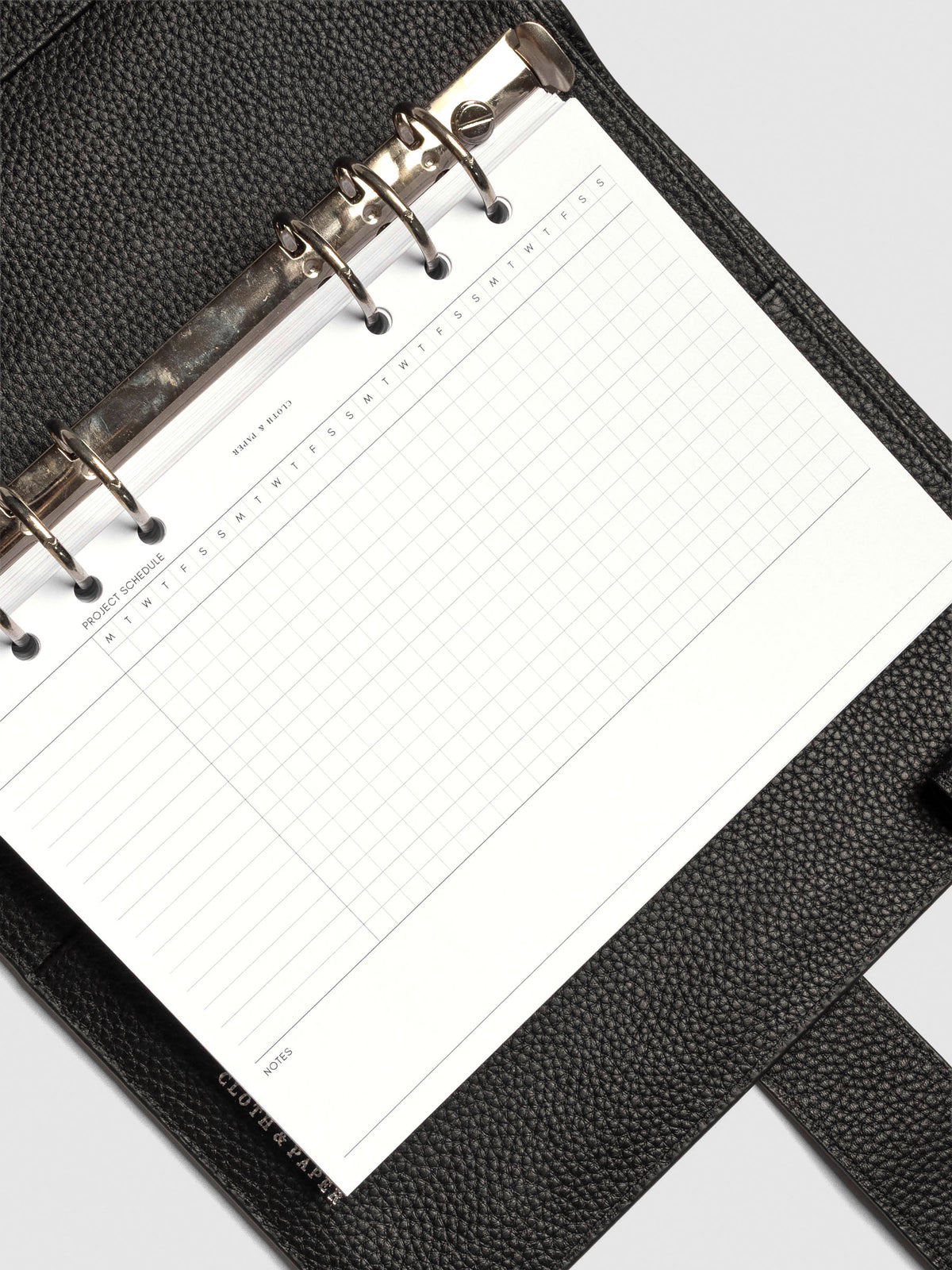 Close up of GanttChart inserts inside discbound planner and leather cover. 