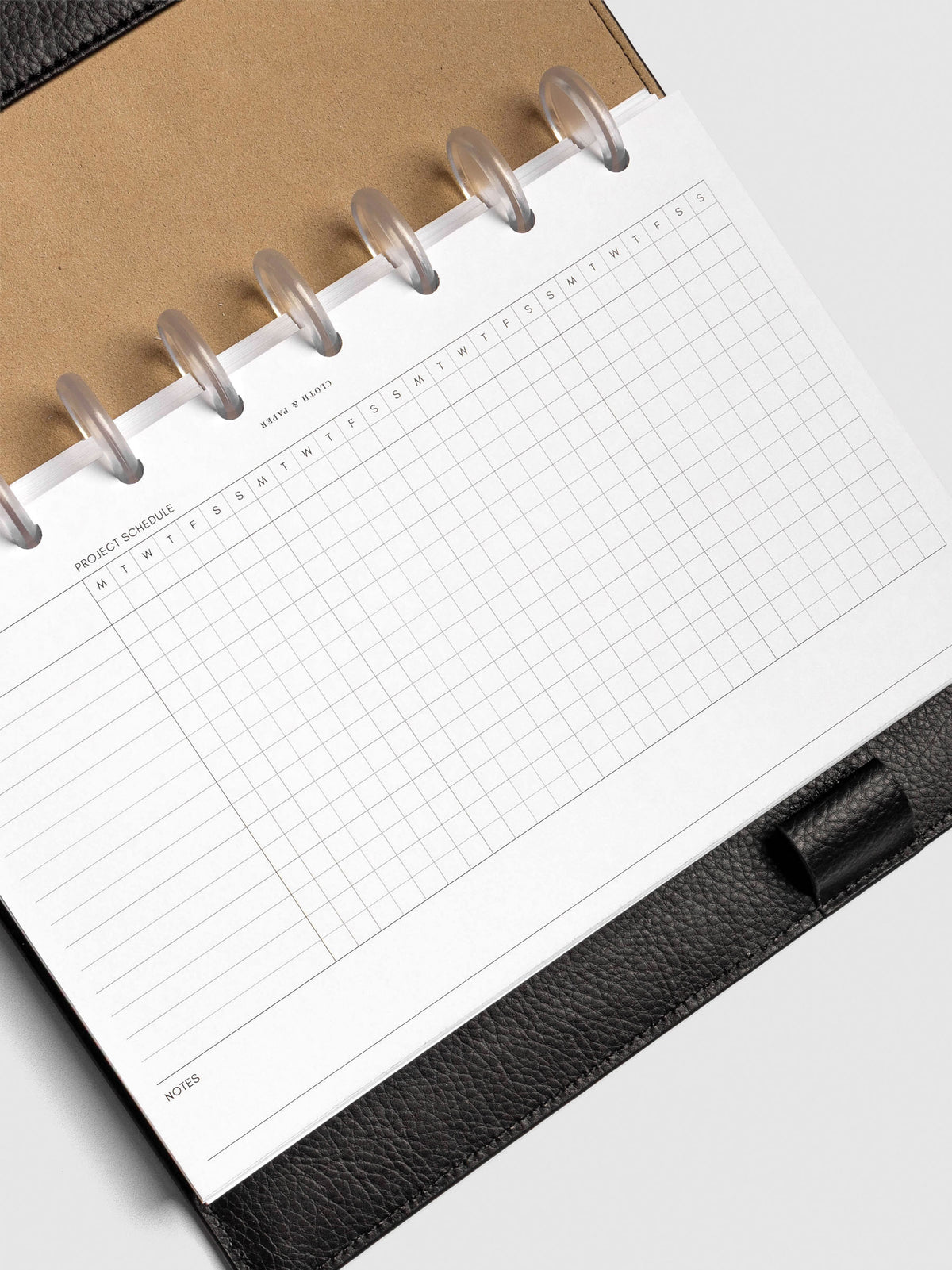 Close up of GanttChart inserts inside discbound planner and leather cover. 