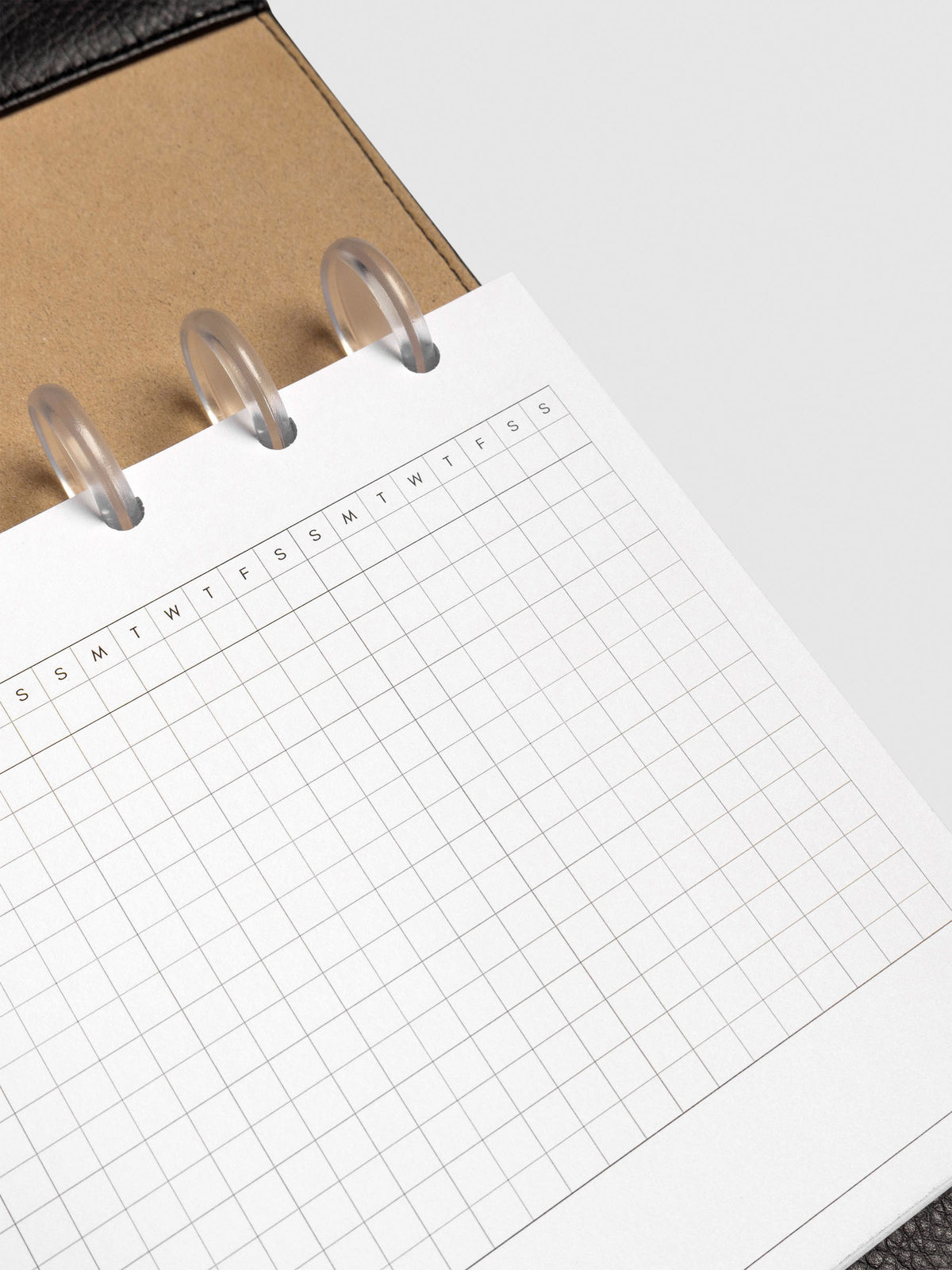 Close up of GanttChart inserts inside discbound planner and leather cover. 