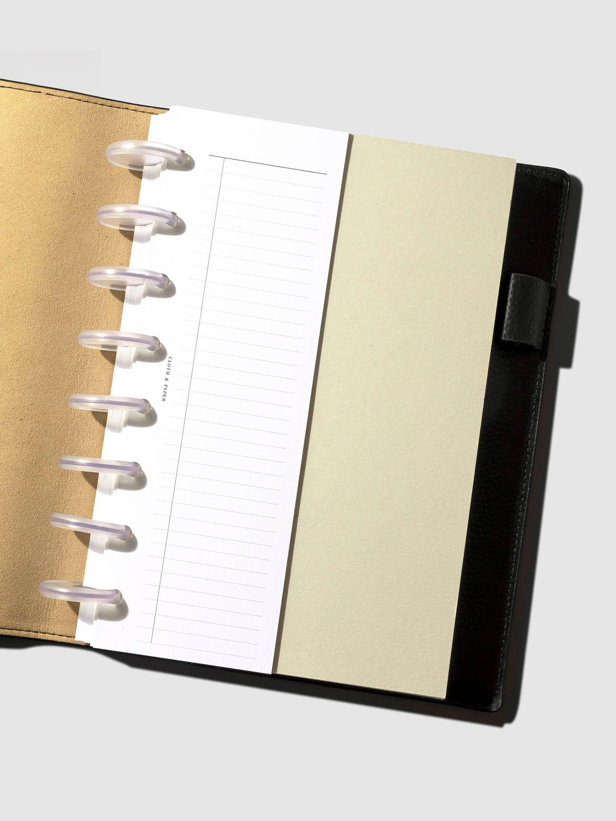 Insert displayed inside a leather planner.