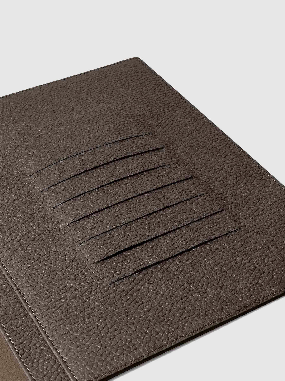 Closeup of credit card slots inside leather folio.