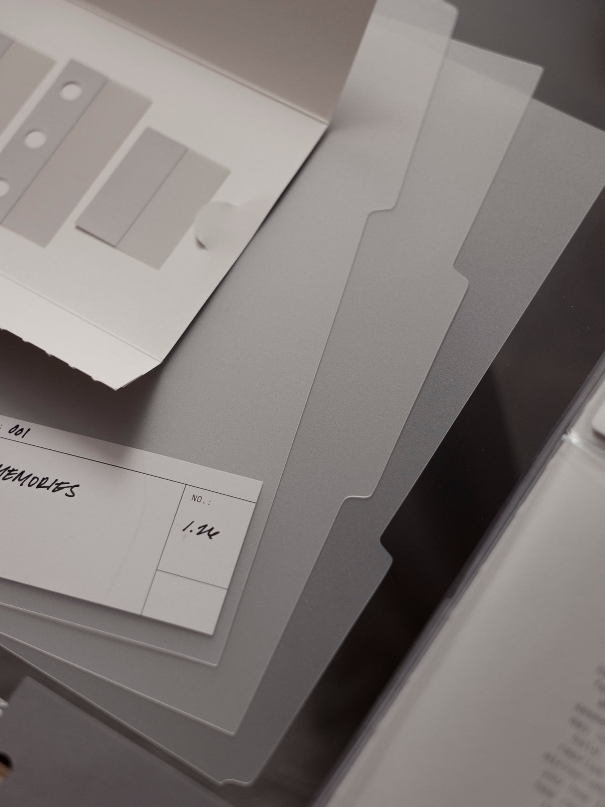 Set of three matte transparent blank side tab dividers with blank white labels shown against a dark background.