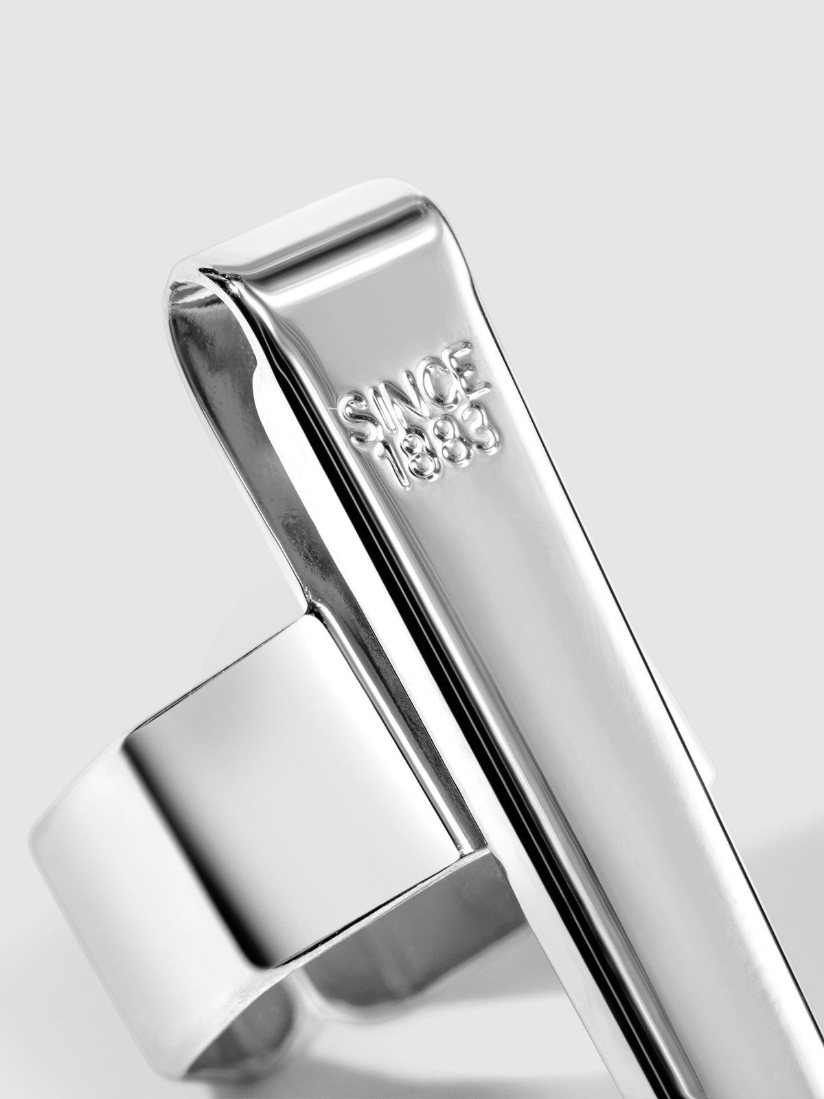 Standard silver  clip displayed on a neutral background. Closeup of text reads "Since 1883"