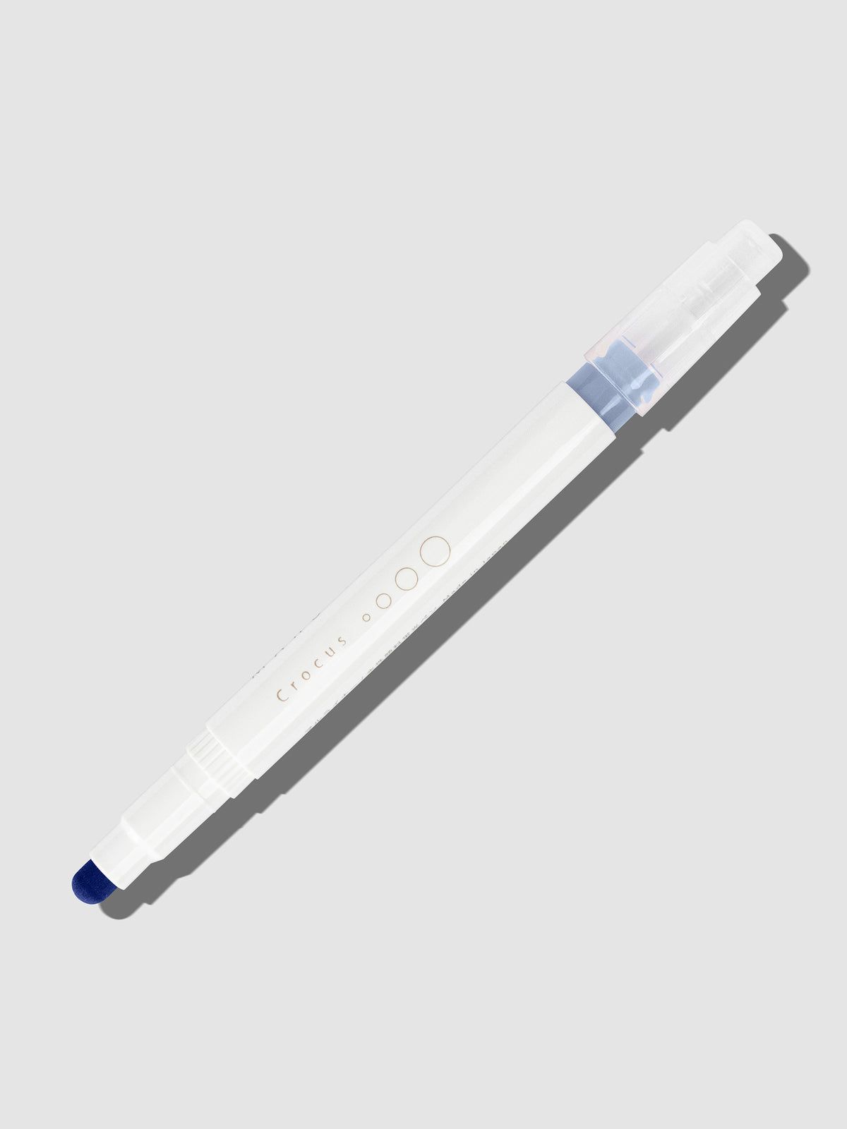 Crocus highlighter with tip exposed and cap posted to the end of its barrel on a neutral background.