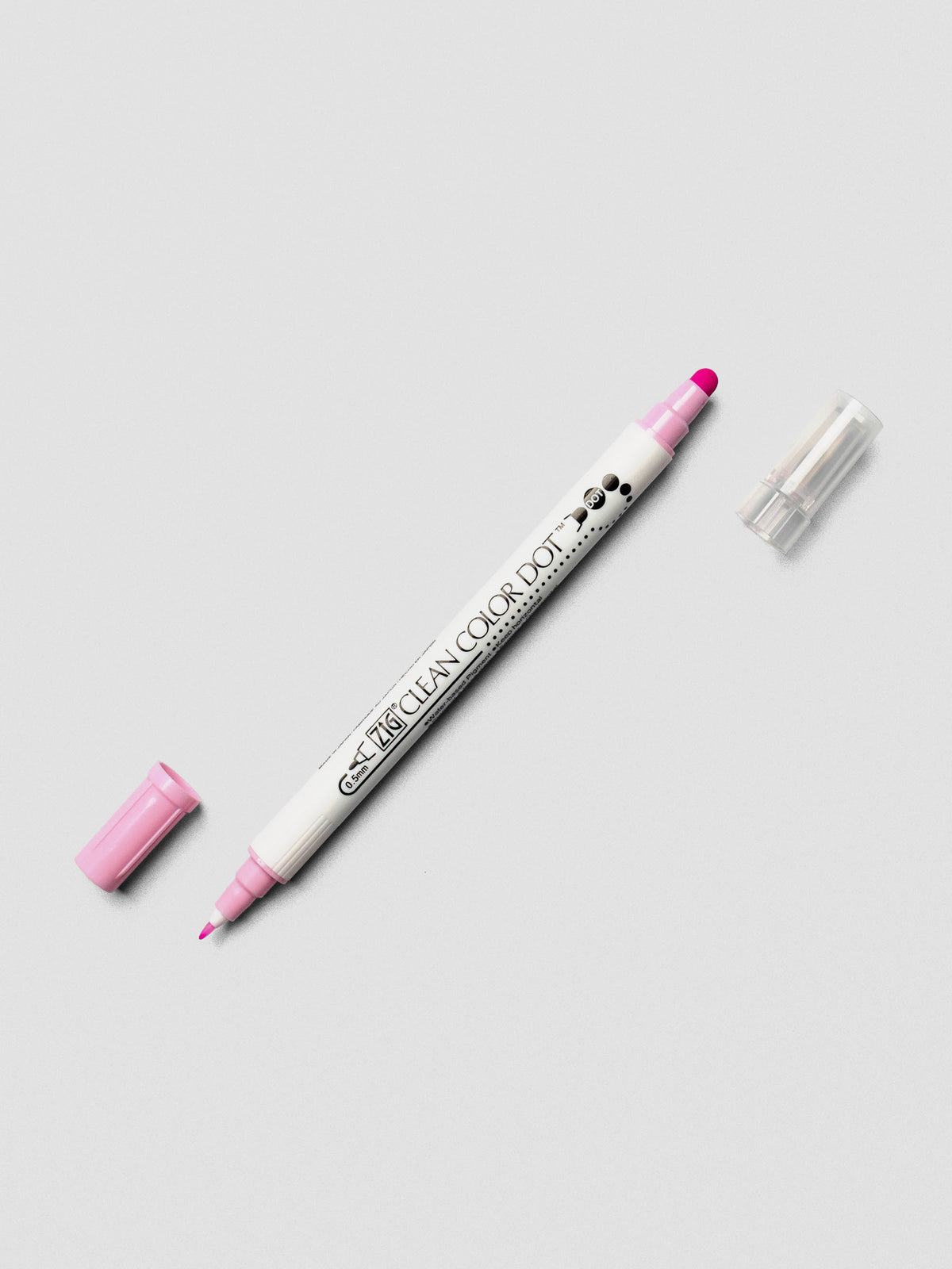 Candy Pink Kuretake ZIG Clean Color Dot Dual Tip Marker with caps off, displaying both the fine tip and dot tip on a light background.