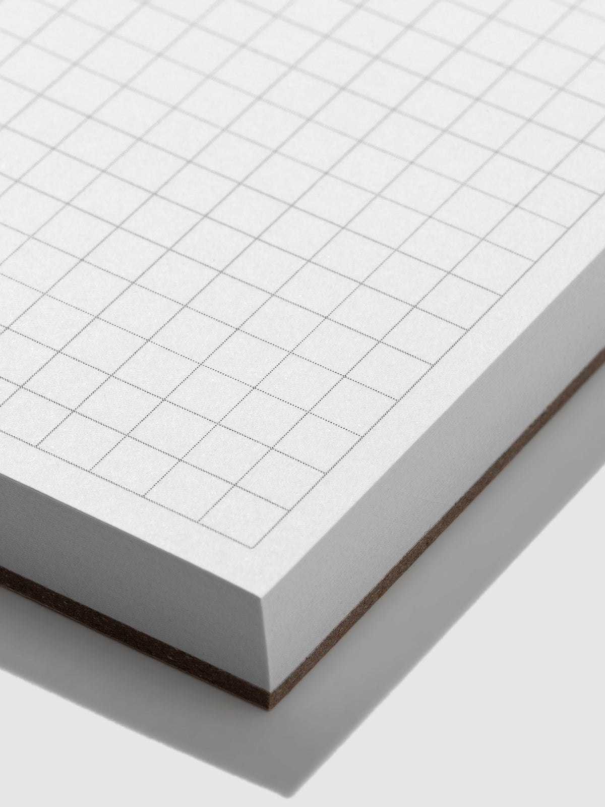 Closeup of the graph grid paper on the notepad.