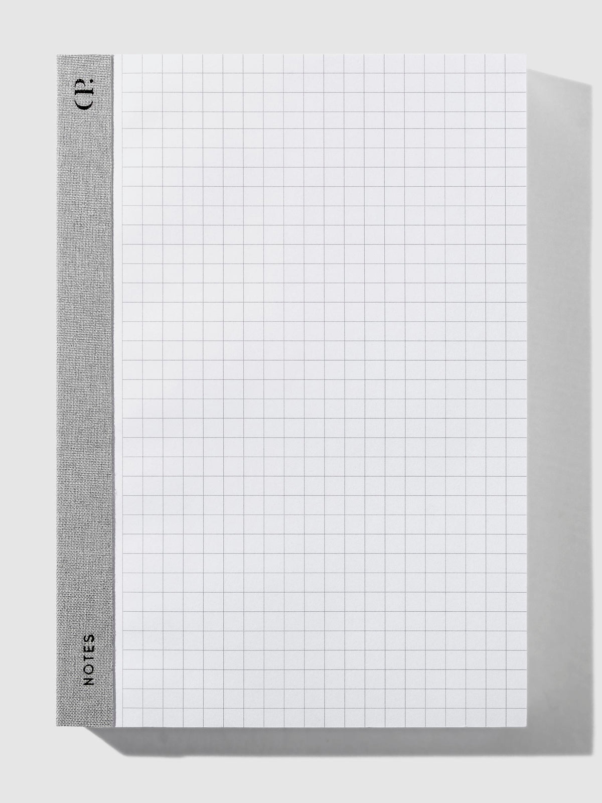 Left Bound Graph Notepad, A5, Cloth and Paper. Notepad positioned vertically on a neutral background. 