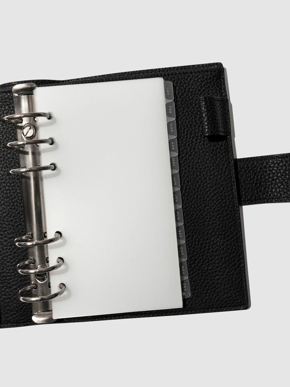 White foil tabs displayed in use inside a black leather folio.