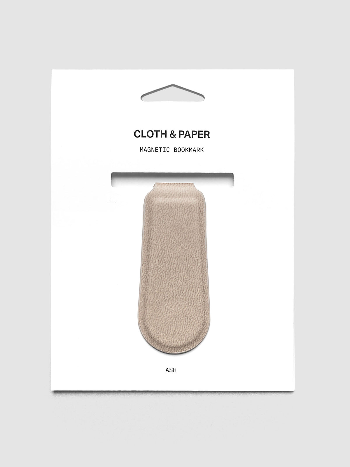 Magnetic Bookmark Smooth Leather in light taupe on retail packaging with product visible through die-cut window