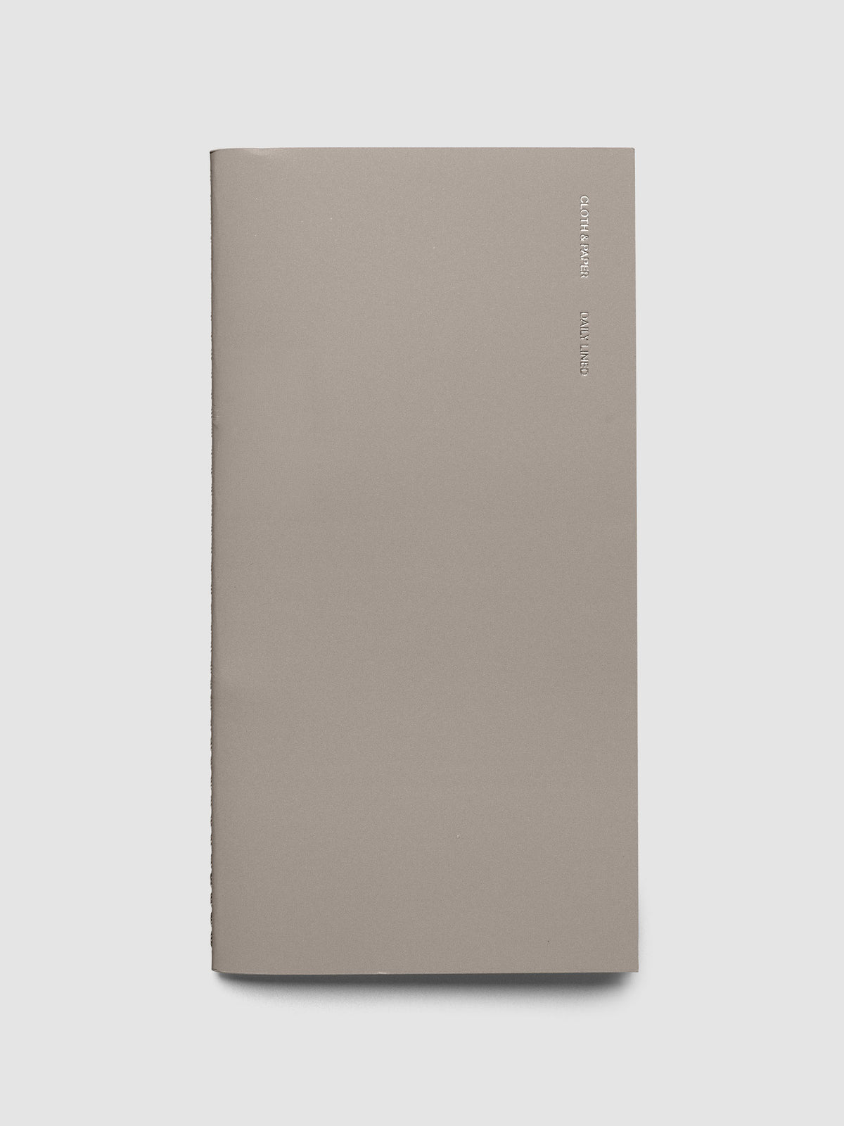 Travel Notebook in size A5 Slim in color Verona shown closed with silver foil CLOTH & PAPER DAILY LINED writing on the top right side.