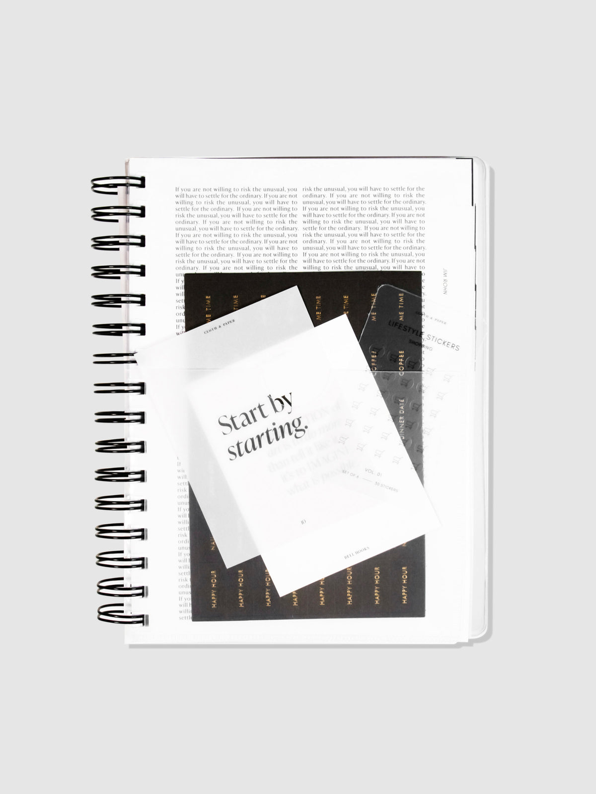 Pocket Folder inside a 2022 Spiral Bound Planner. Journaling cards and planning stickers are tucked into the pocket, and the planner on a neutral background.