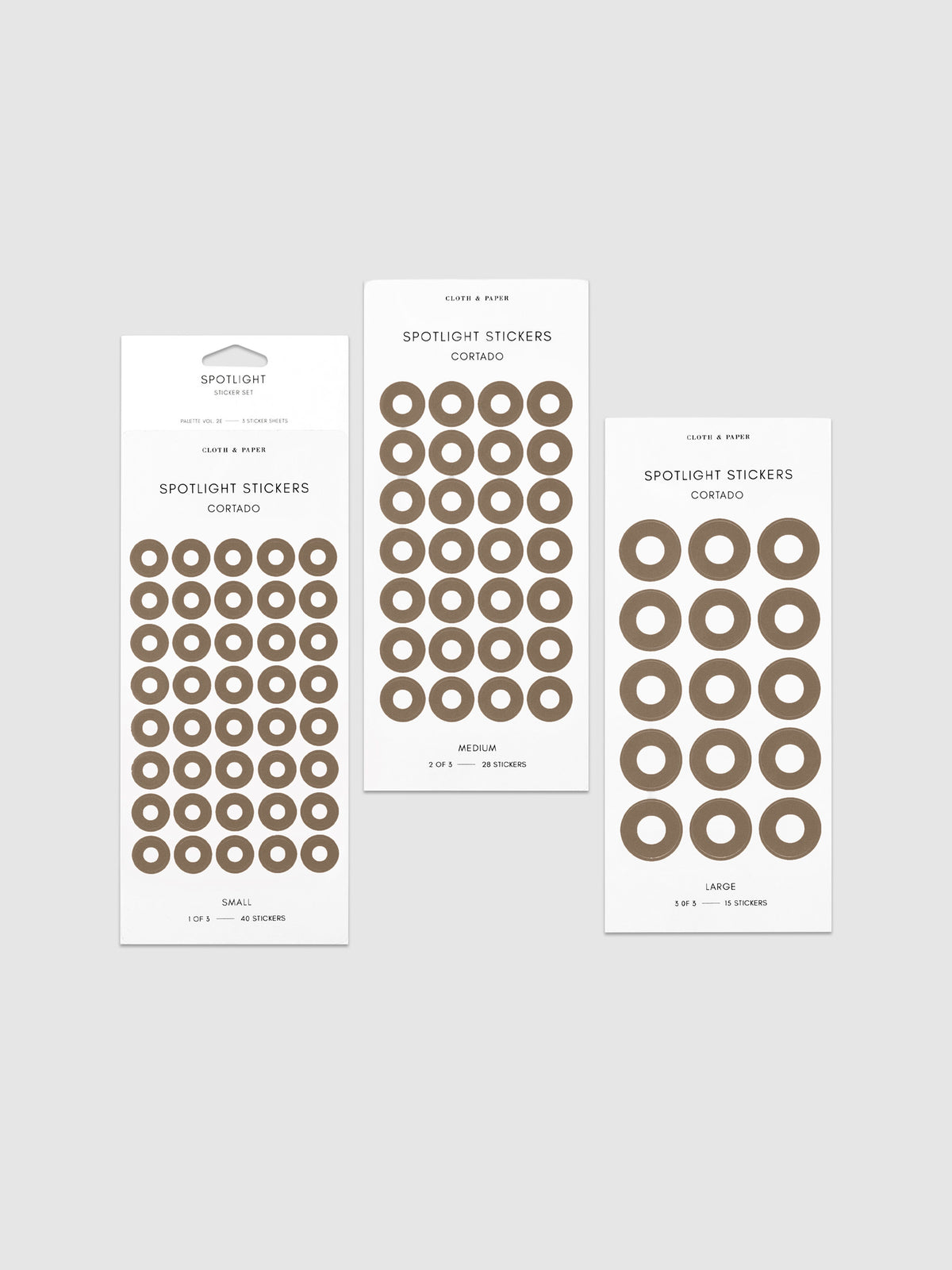 Three sheets of spotlight stickers in small, medium, and large sizing arranged together on a neutral background.