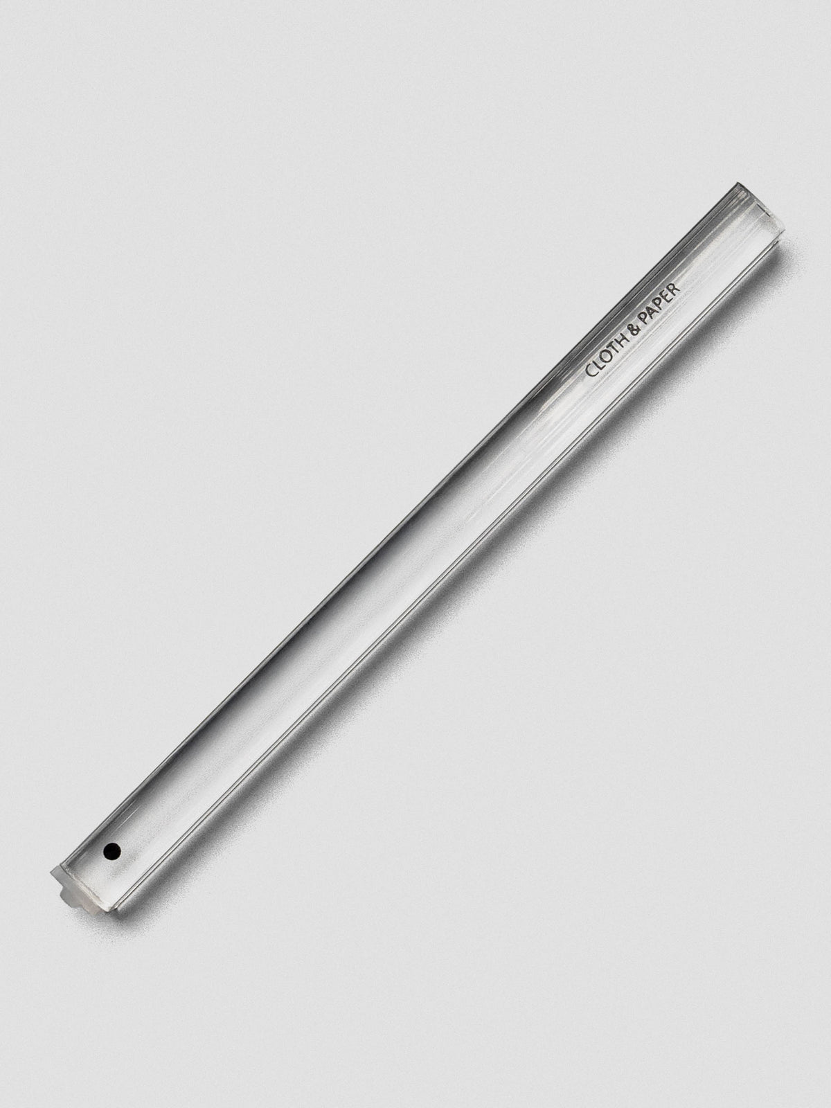 Single clear acrylic stamp stick with a filled black circle icon on the end and the Cloth & Paper logo on the side.