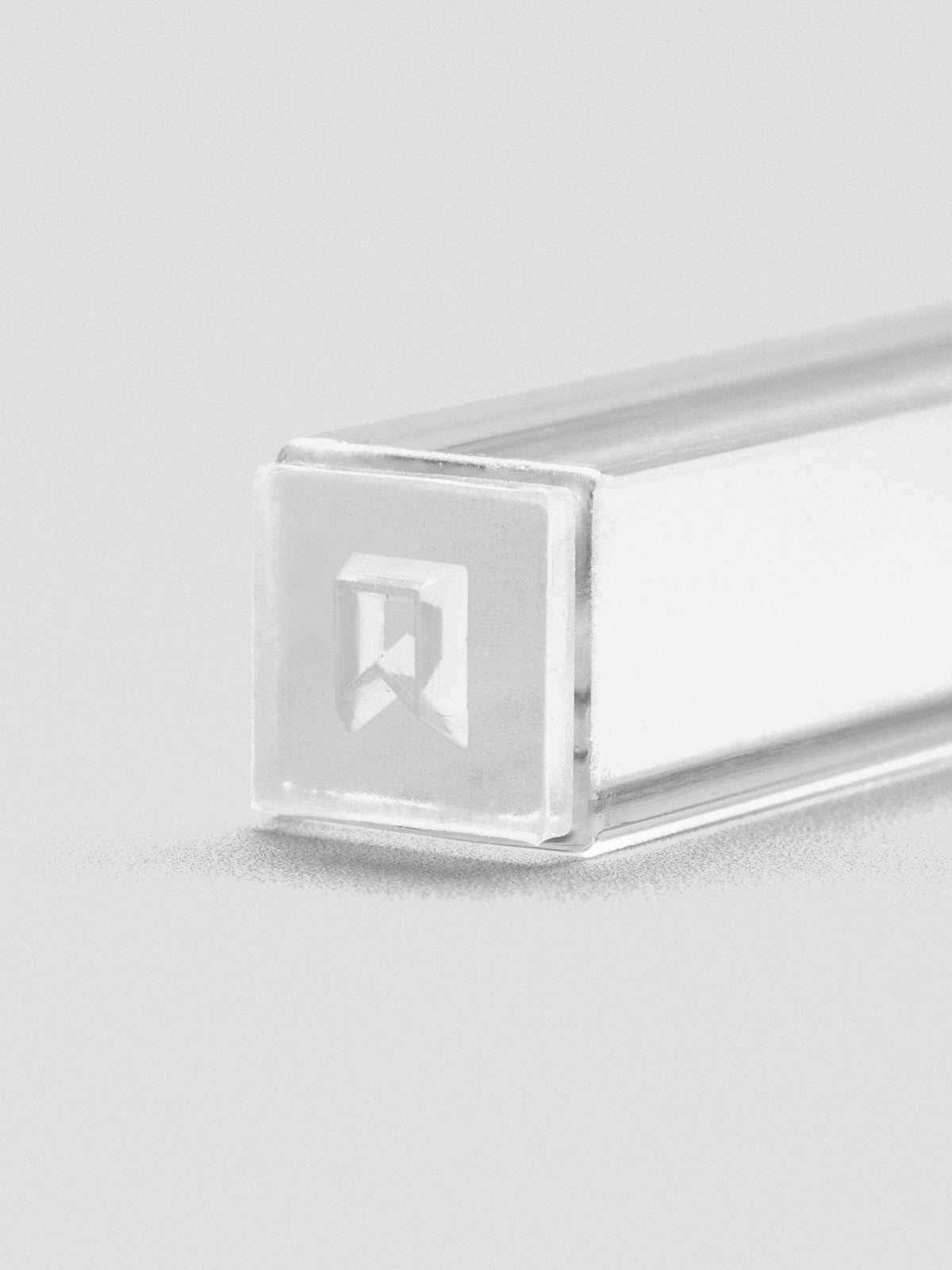 Close-up of stamp stick end with an engraved flag icon.