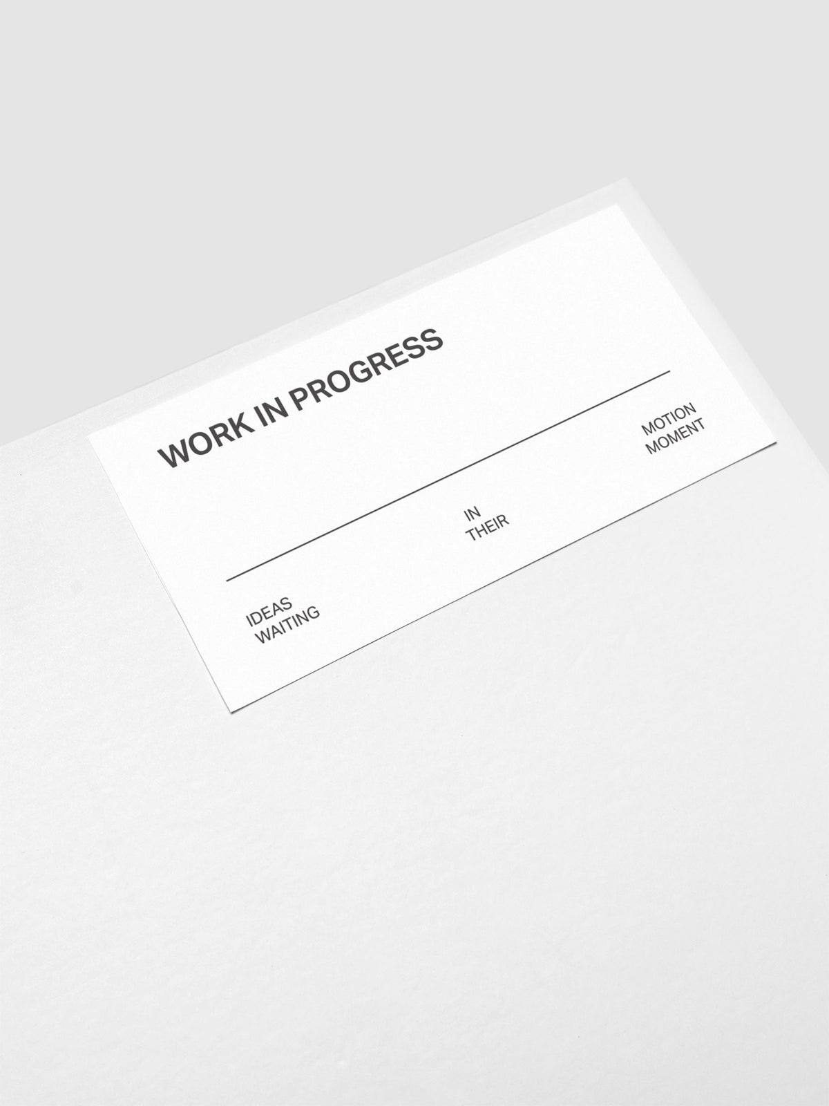 Close up of the Work In Progress label sticker applied to the exterior of the Storage Book 4.0.