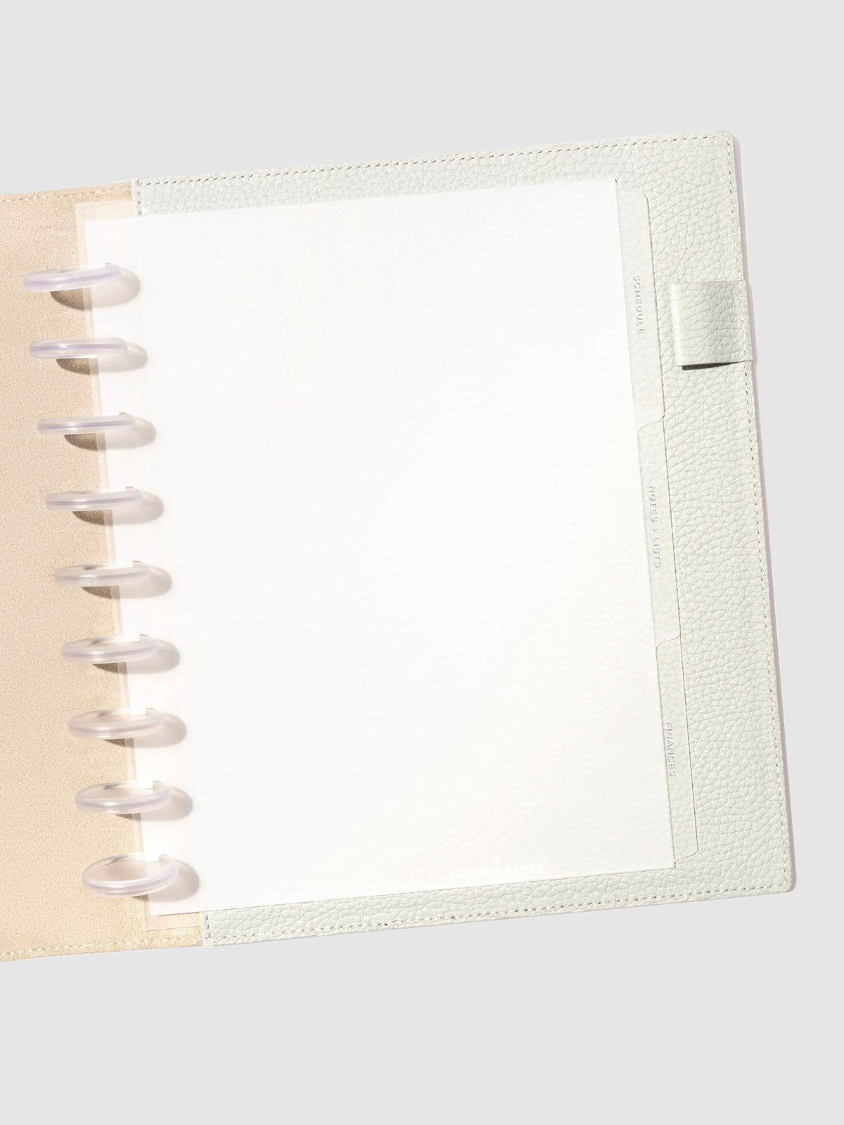 White foil tabs displayed in use inside a  leather folio.