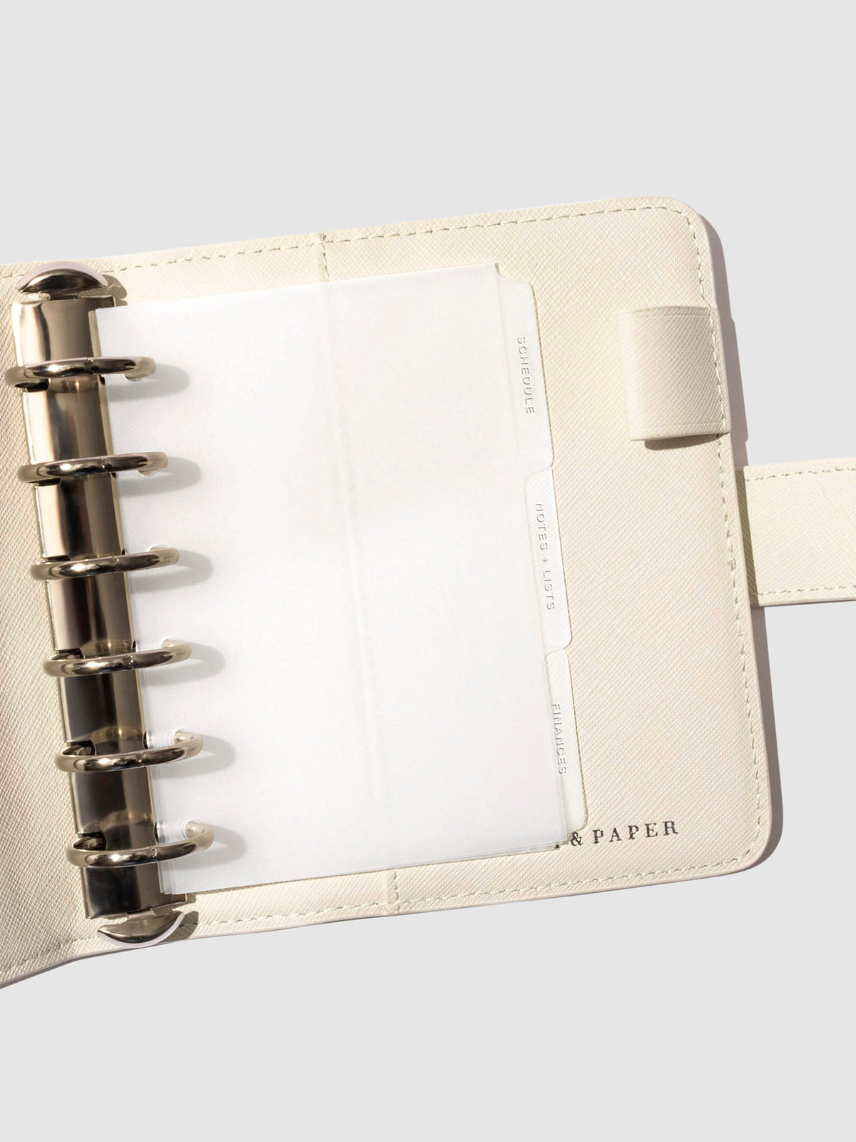 White foil tabs displayed in use inside a  leather folio.