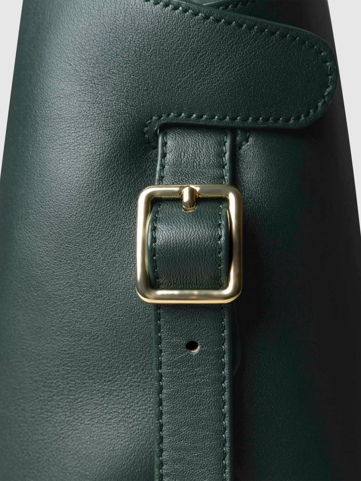 Side view of bag showcasing its gold hardware and adjustable leather strap. Color shown is Salamanca.