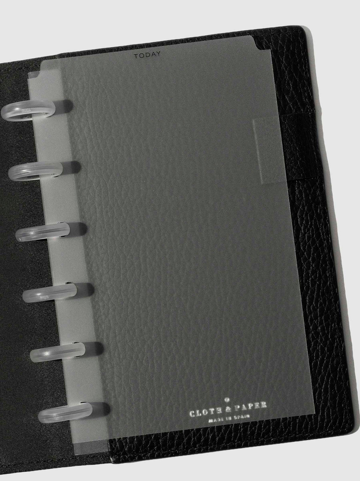Black foil divider displayed in a black leather planner.