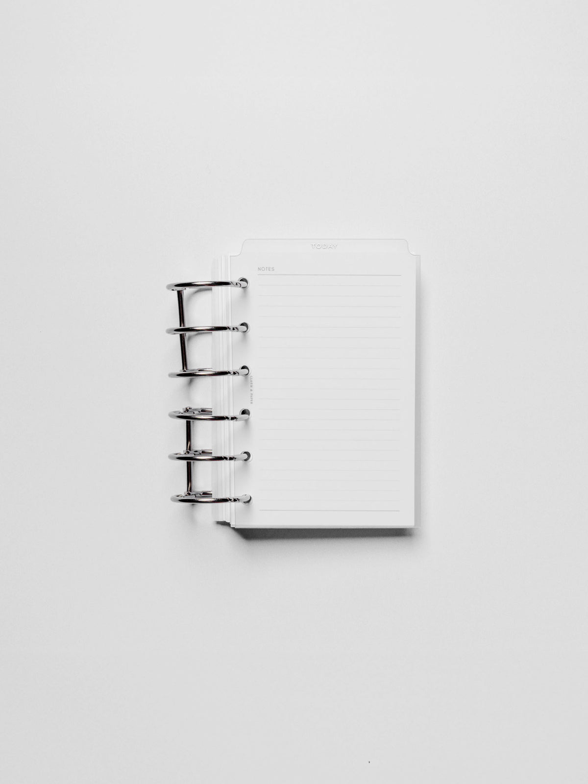 White foil divider displayed in a metal ring.