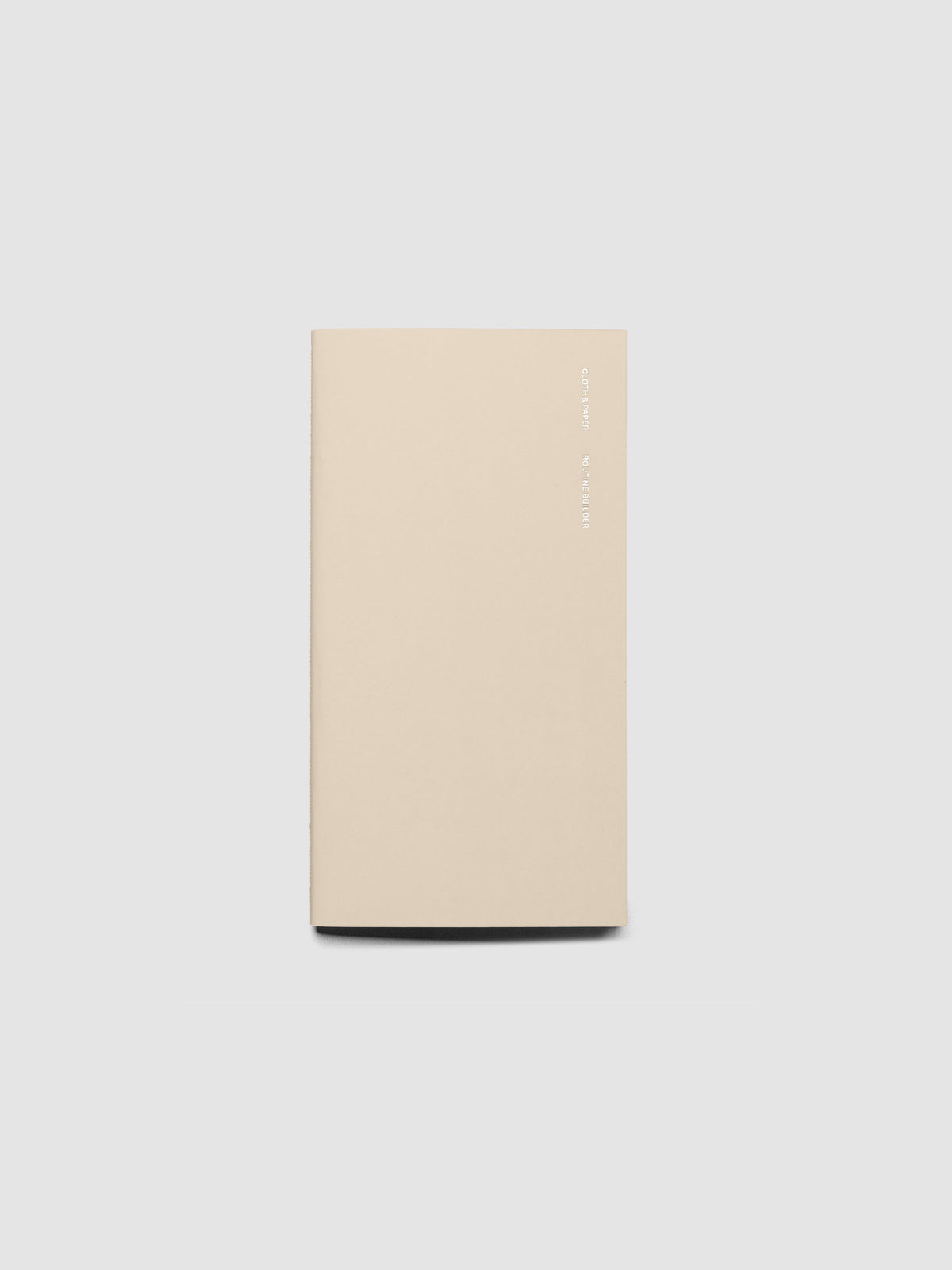 Overview image of the Routine Builder Pocket Plus travel notebook in Beignet with silver foil cover text, displayed on a light gray background