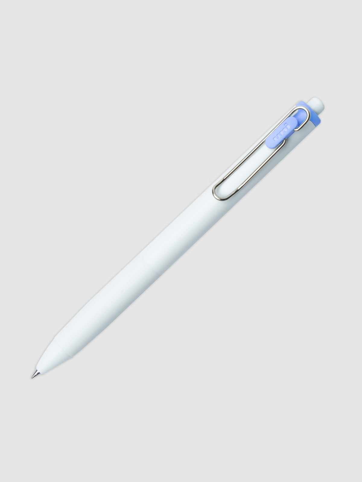 Uni-ball One Gel Pen, Blue Colon, Cloth and Paper. Pen tilted slightly to the right on a neutral background.