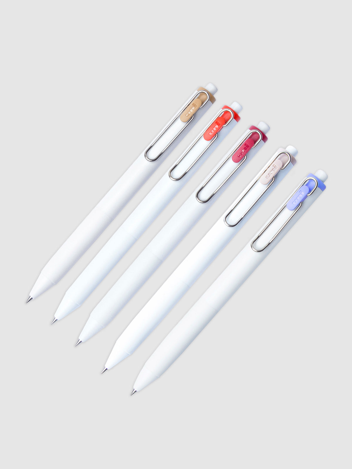 5 Uni-ball One Gel Pens with 0.38 mm nibs arranged parallel to each other. All are turned to the right against a neutral background.