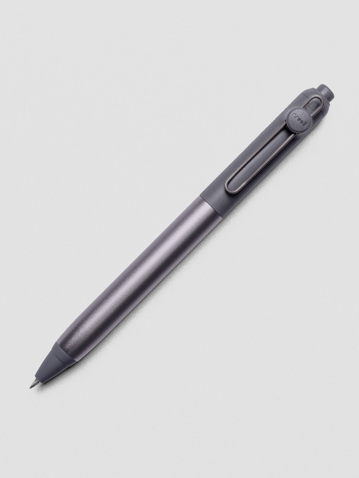 Grey pen shown at an angle on a grey background.