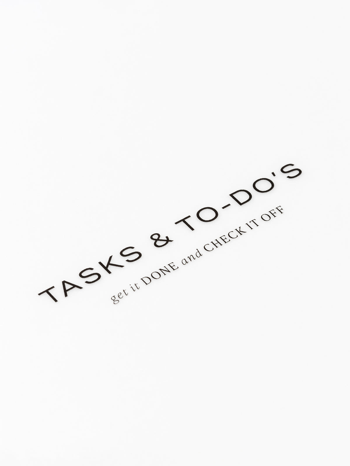 Closeup of text reading "tasks and to-do's | get it done and check it off"