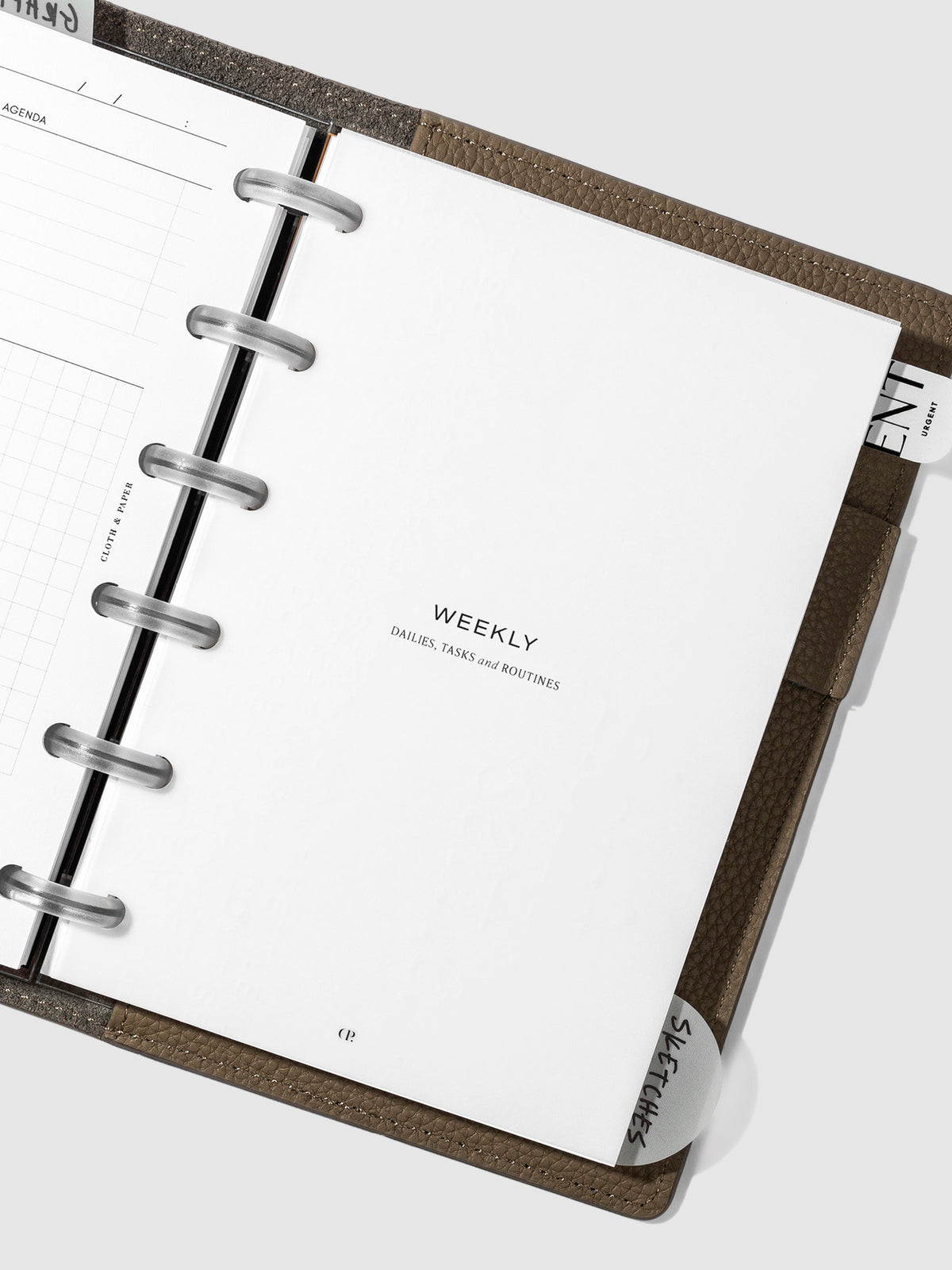 Weekly dashboard in use inside a leather planner.