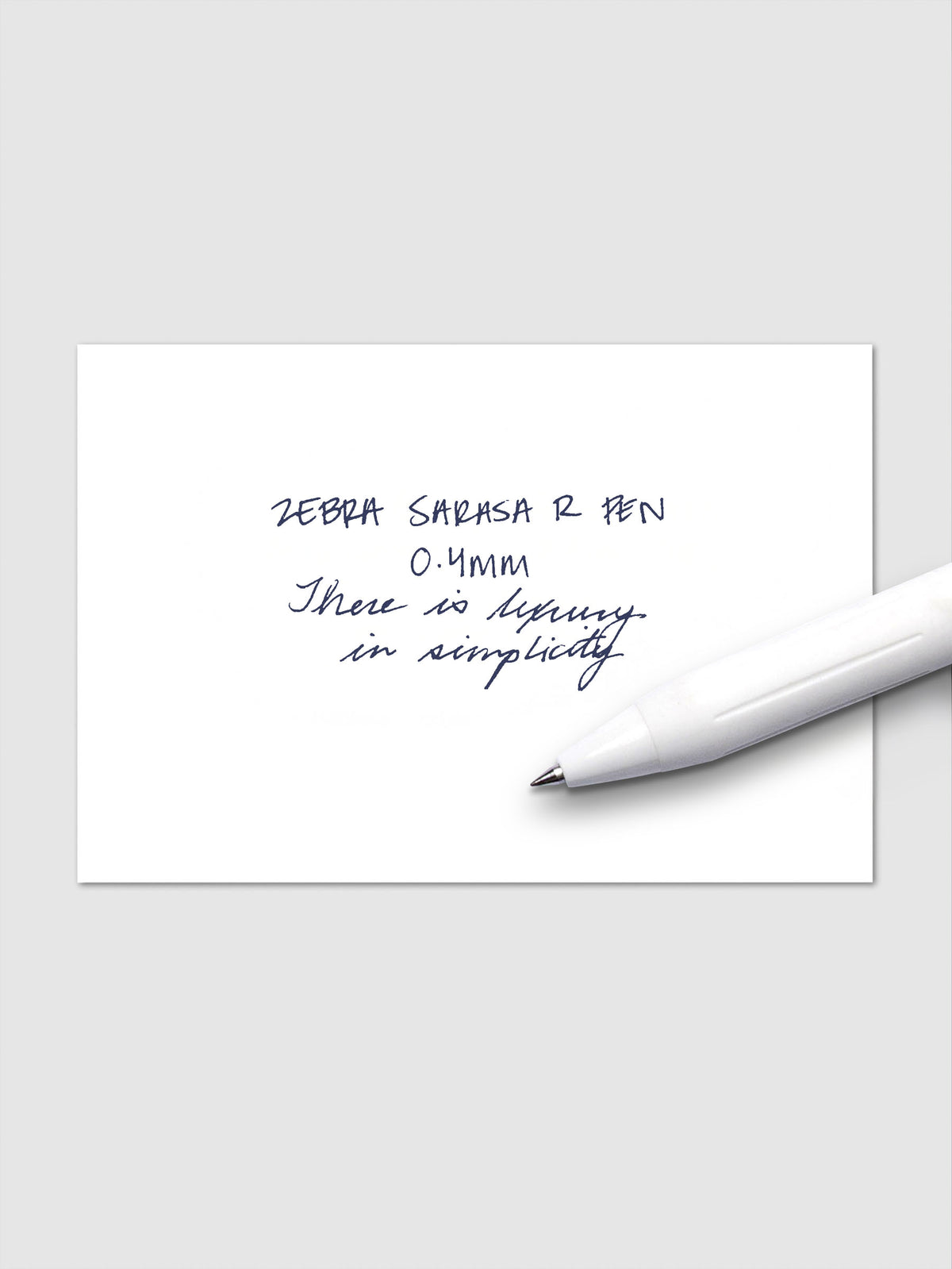 Writing sample using Zebra Sarasa R 0.4mm pen in blue-black ink on white paper.