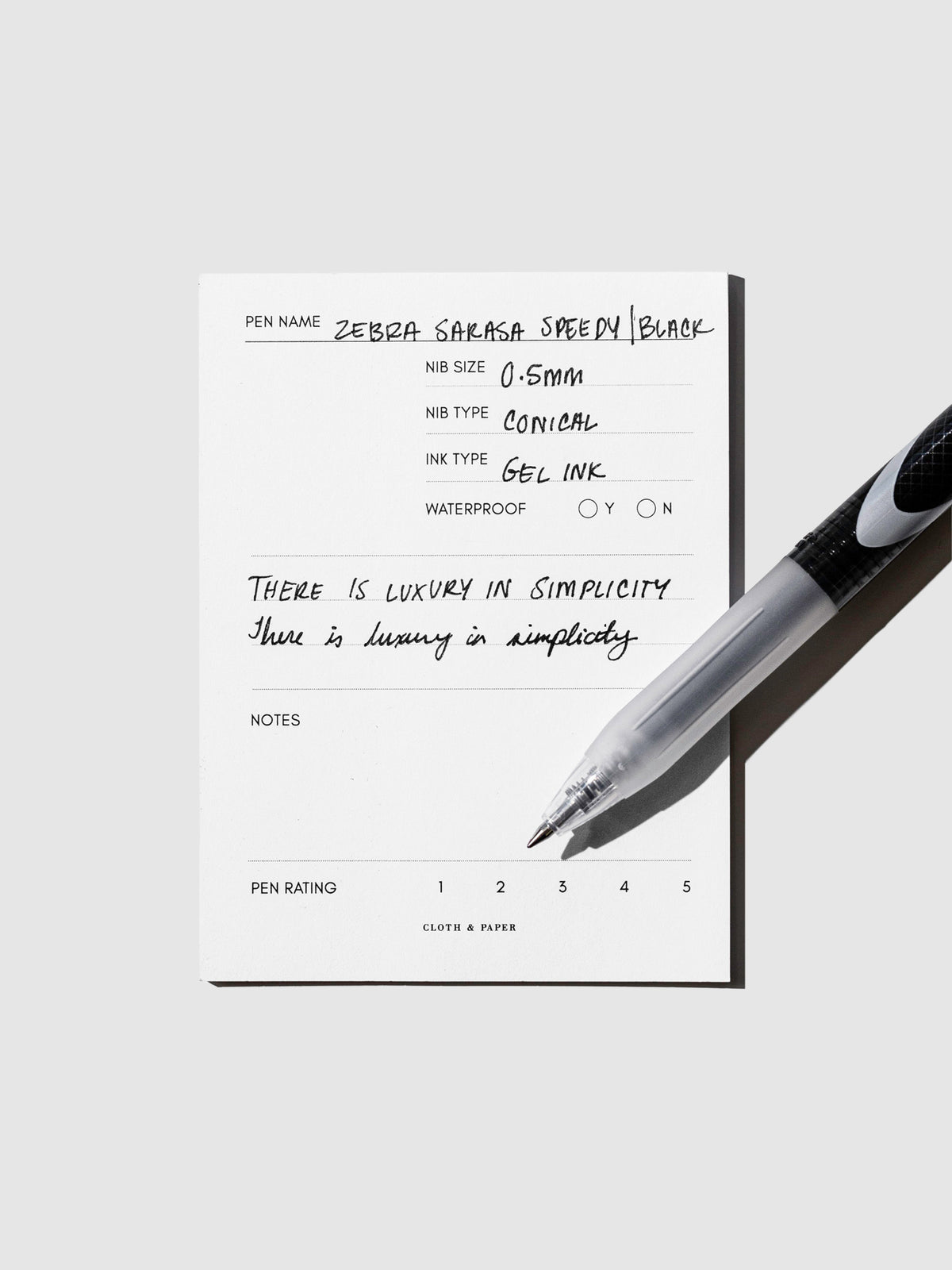 Pen displayed on top of an in use pen testing sheet.