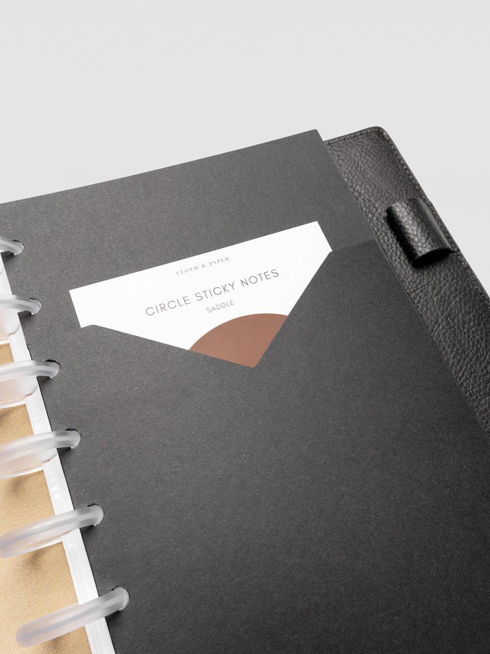 Detail view of the black planner paper pocket folder shown in size Half Letter 8-Disc Punch