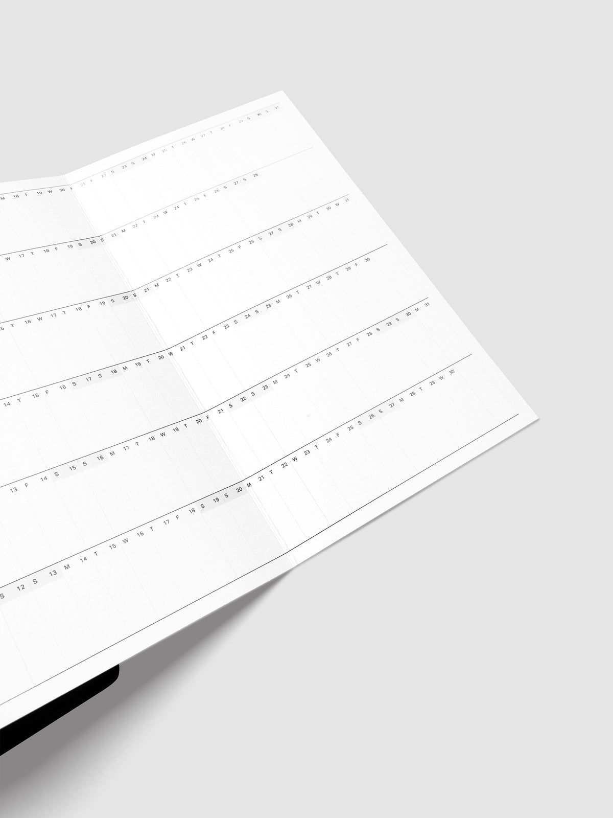 Detail view of the 2027 Dated Fold Out Insert fully unfolded inside a Half Letter 8-Disc Punch discbound planner, showing six months of dated calendar boxes across one side.
